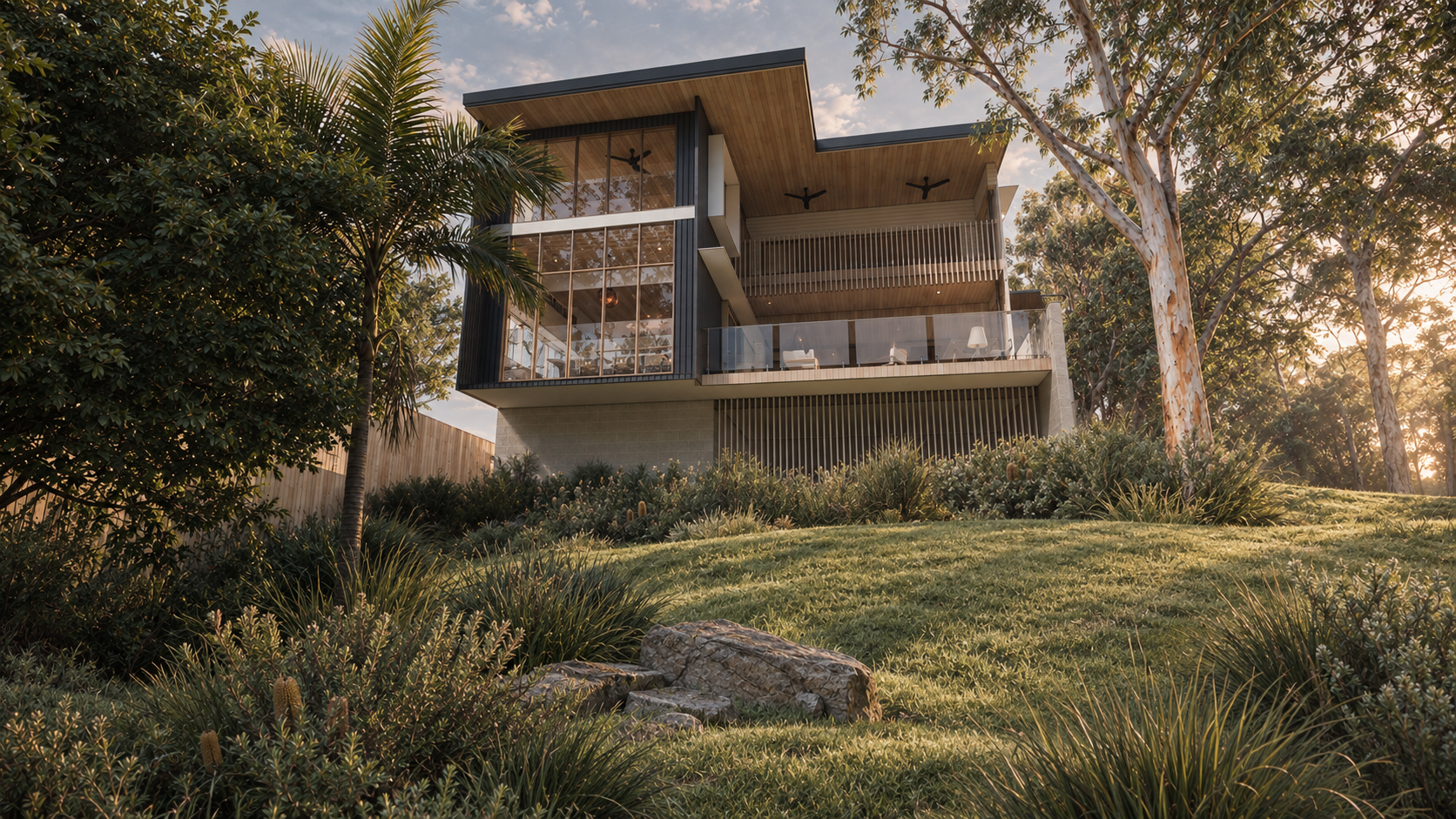 Modern house with large glass windows and wooden accents, surrounded by trees and lush grass at sunset.