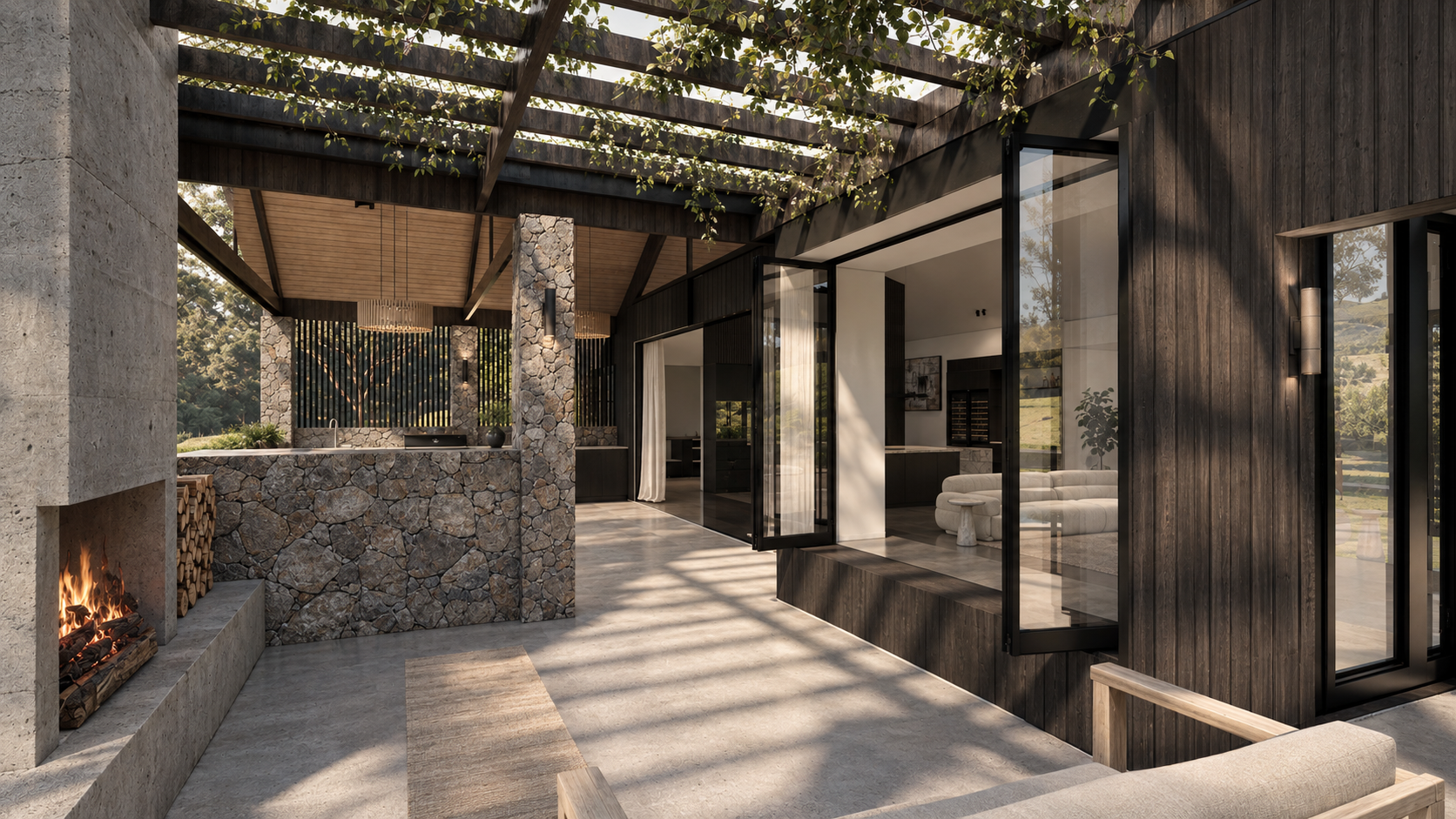 Modern rustic indoor-outdoor living space with stone fireplace, outdoor kitchen, wood pergola, and glass walls