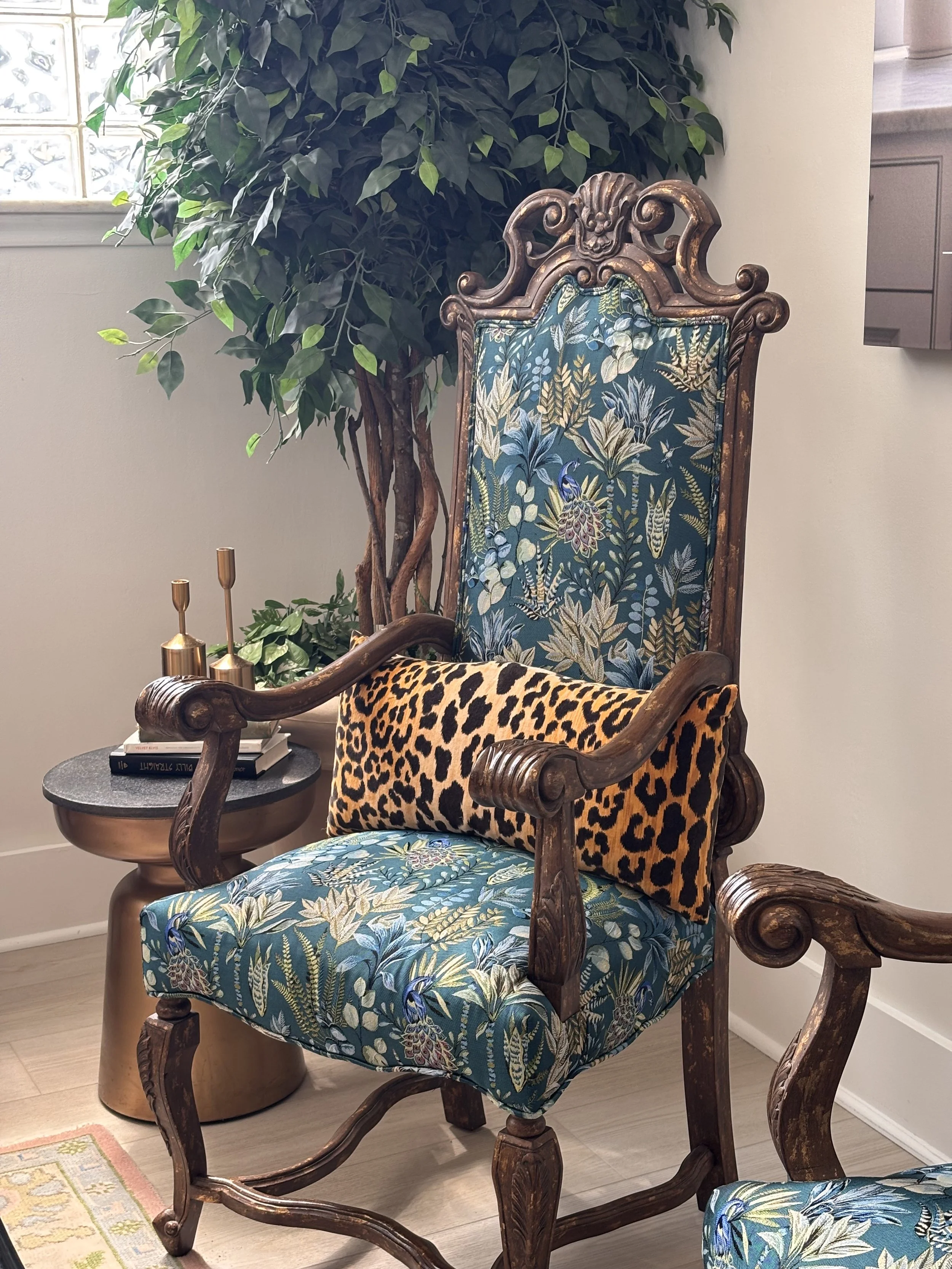Vintage floral pattern chair with leopard print pillow.