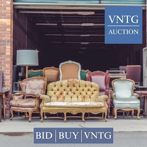 A collection of vintage sofas and chairs displayed outside a building with a blue sign reading 'VNTG AUCTION'.