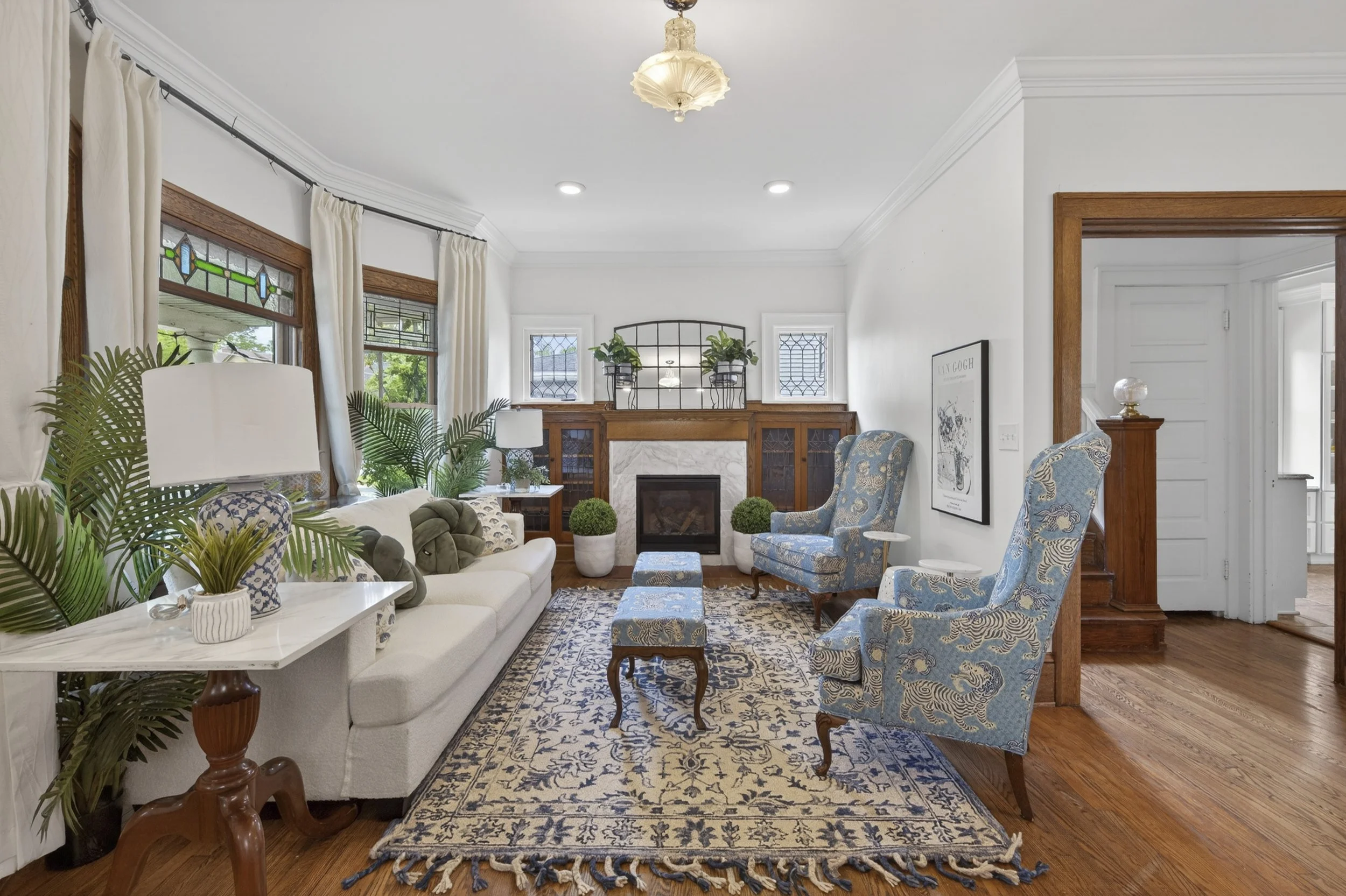 Restored historic living room with original woodwork and blue-and-white decor by VNTG Home in Cleveland, Ohio