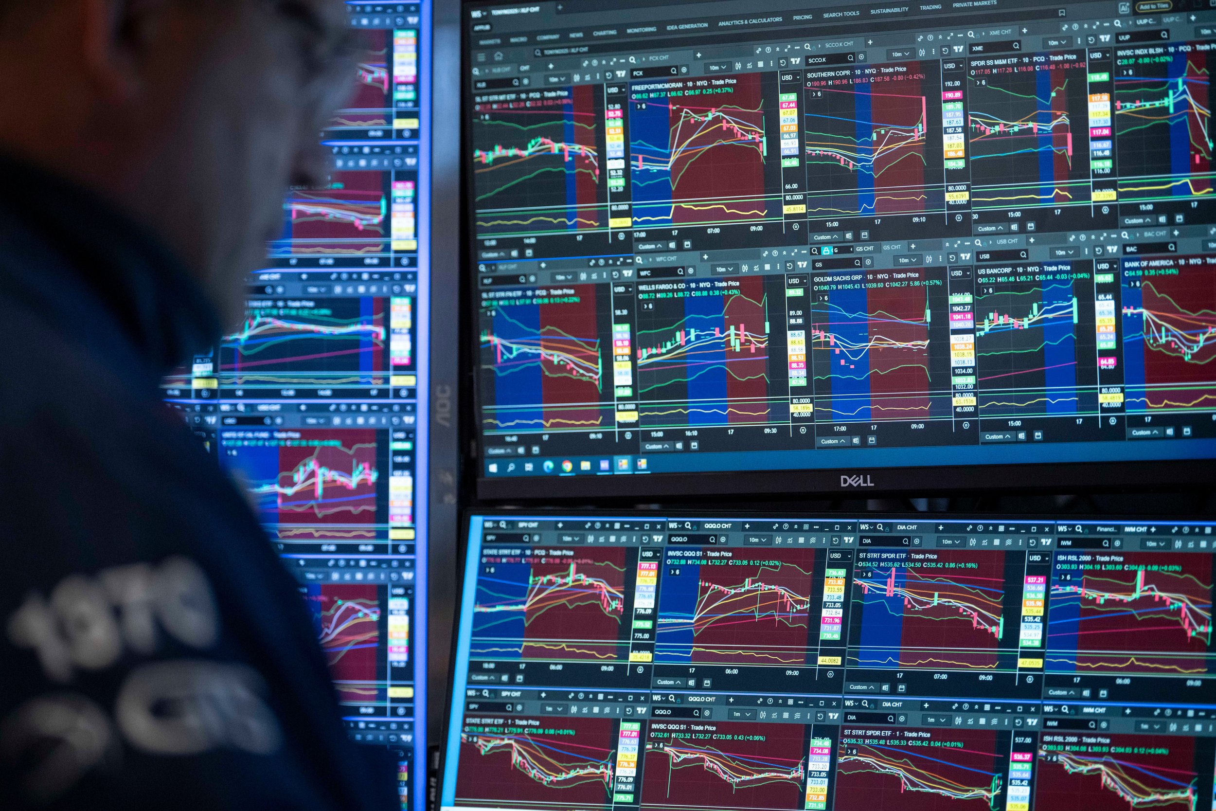 A trader looks at screens on the floor of the New York Stock Exchange