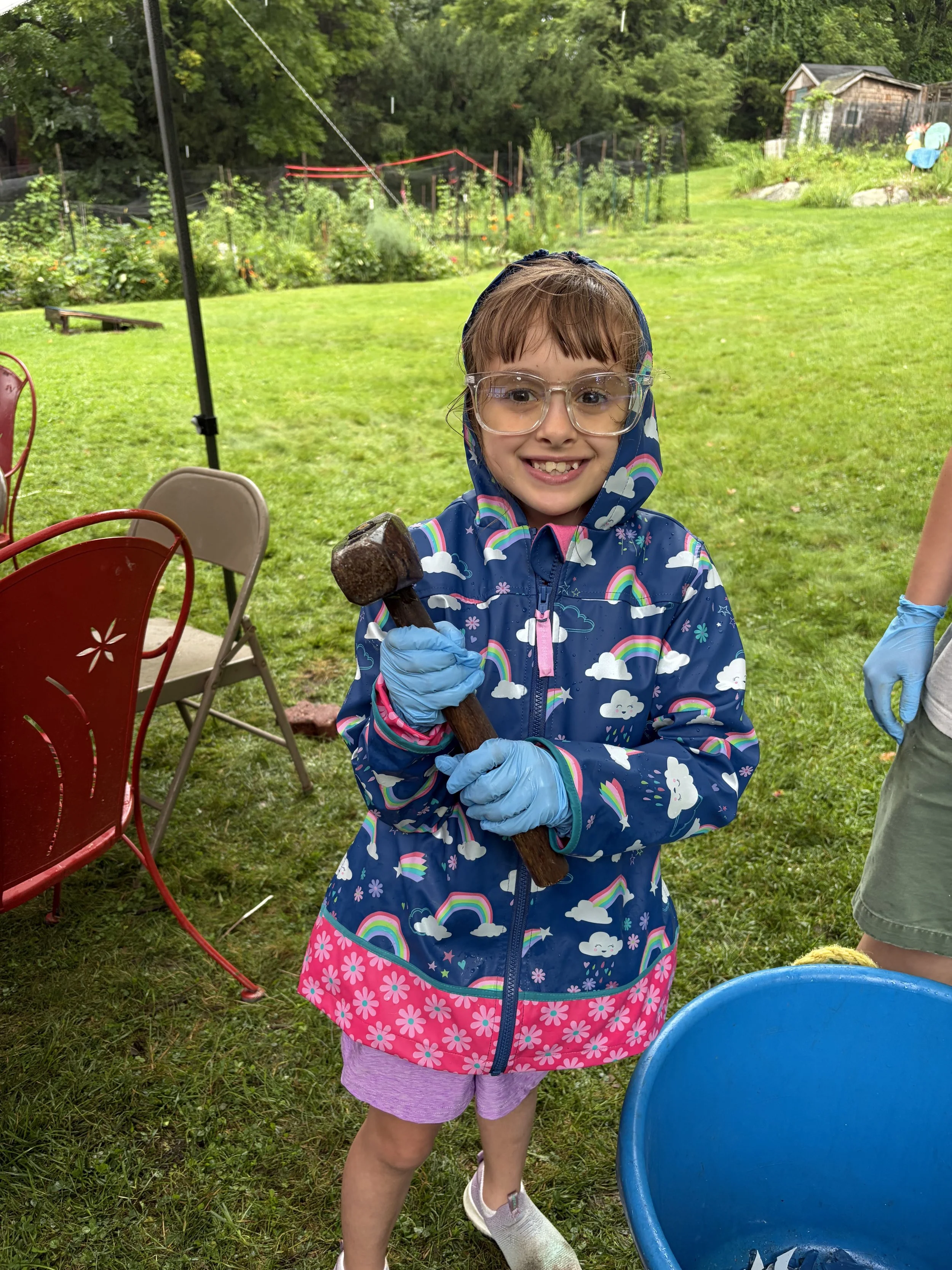 Campers ages 6-11 learn new skills like how to use a hammer and nails at Farm Camp