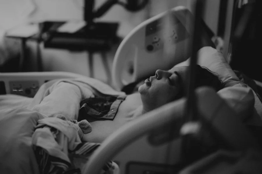 Seattle hospital birth mom resting after baby born 