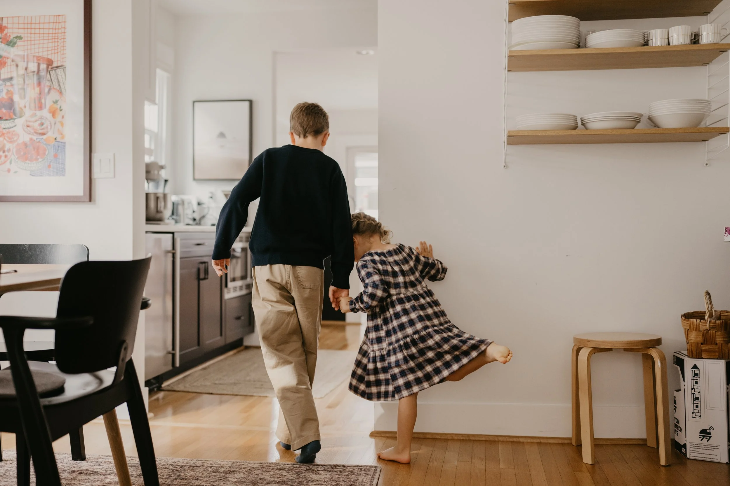 yourng children walking together in their home