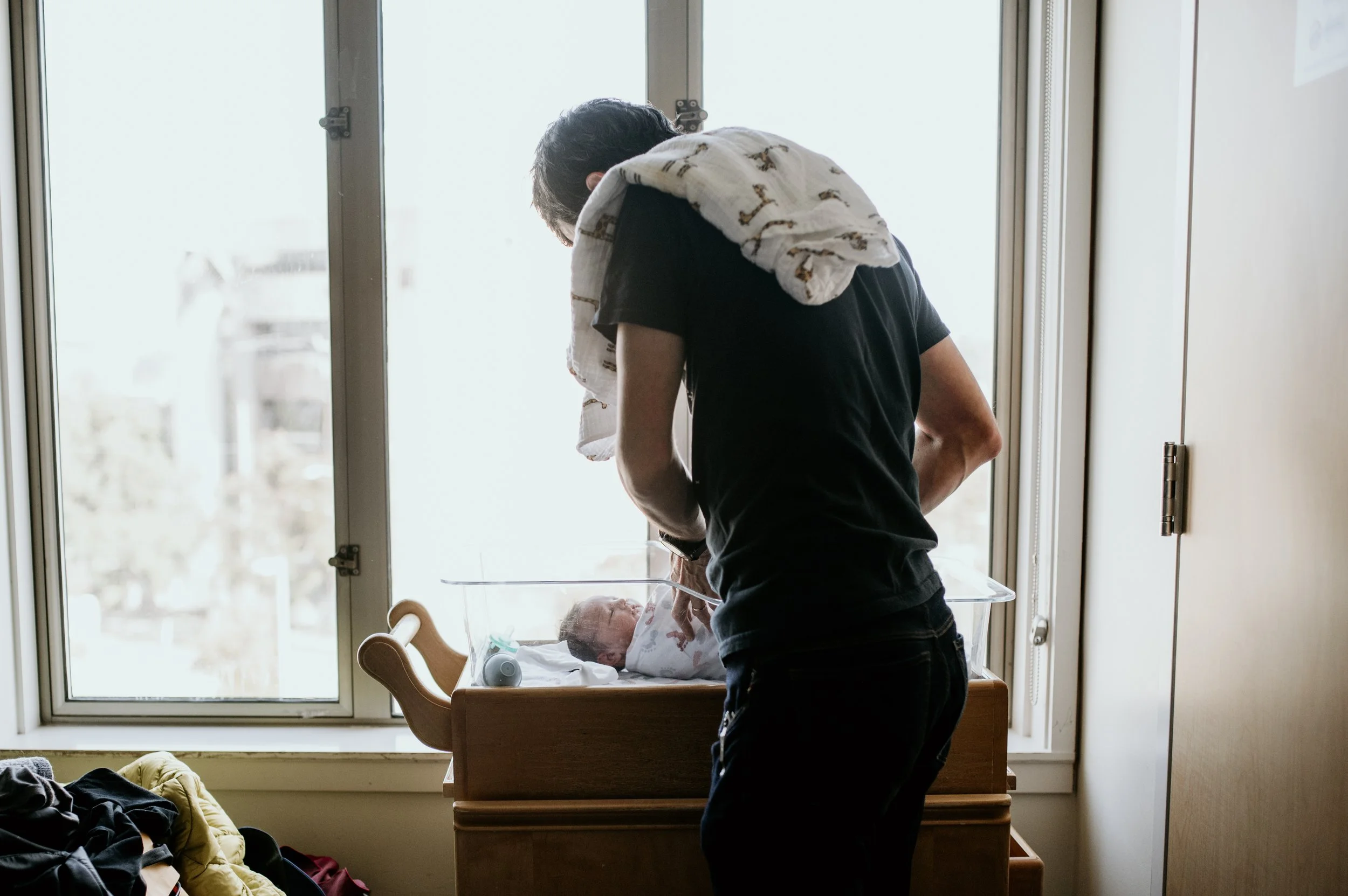 dad changing baby in hospital at fresh 48 photo session 