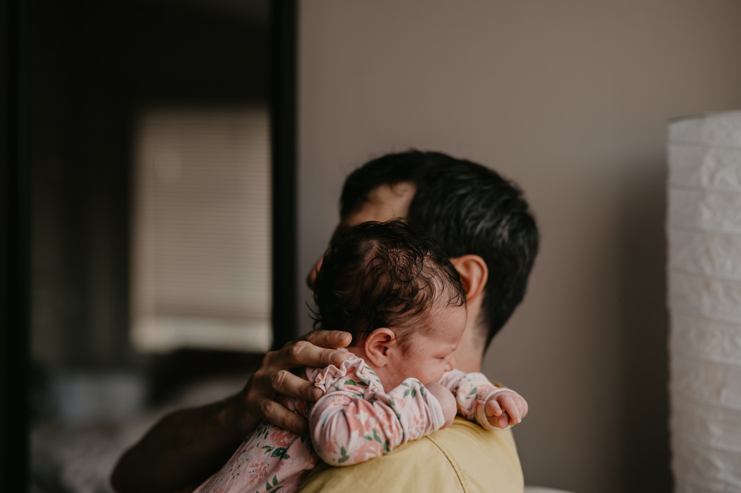 newborn at home photography baby on dad's shoulder