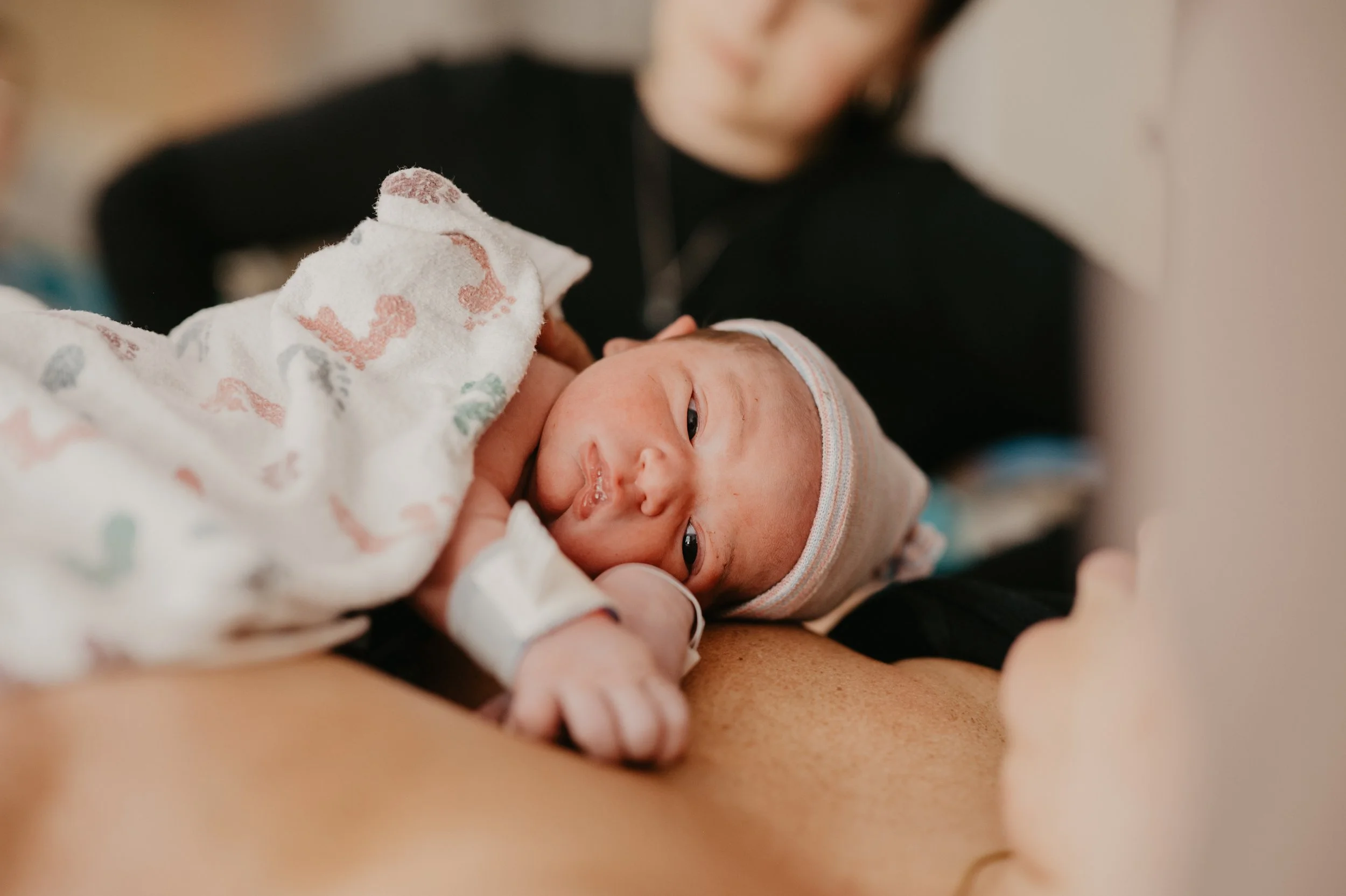 birth session seattle baby looking at camera in hospital