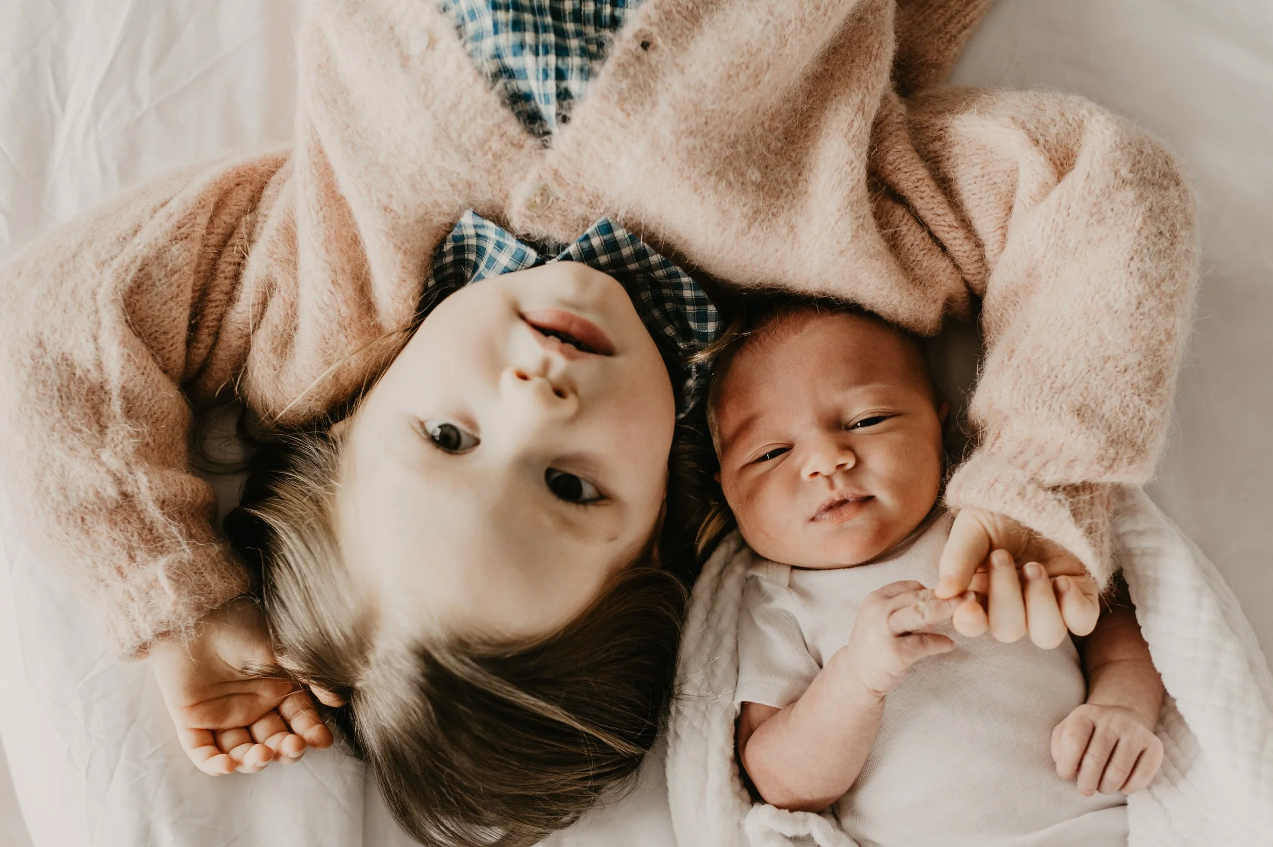Photo of sisters at in home newborn photography session