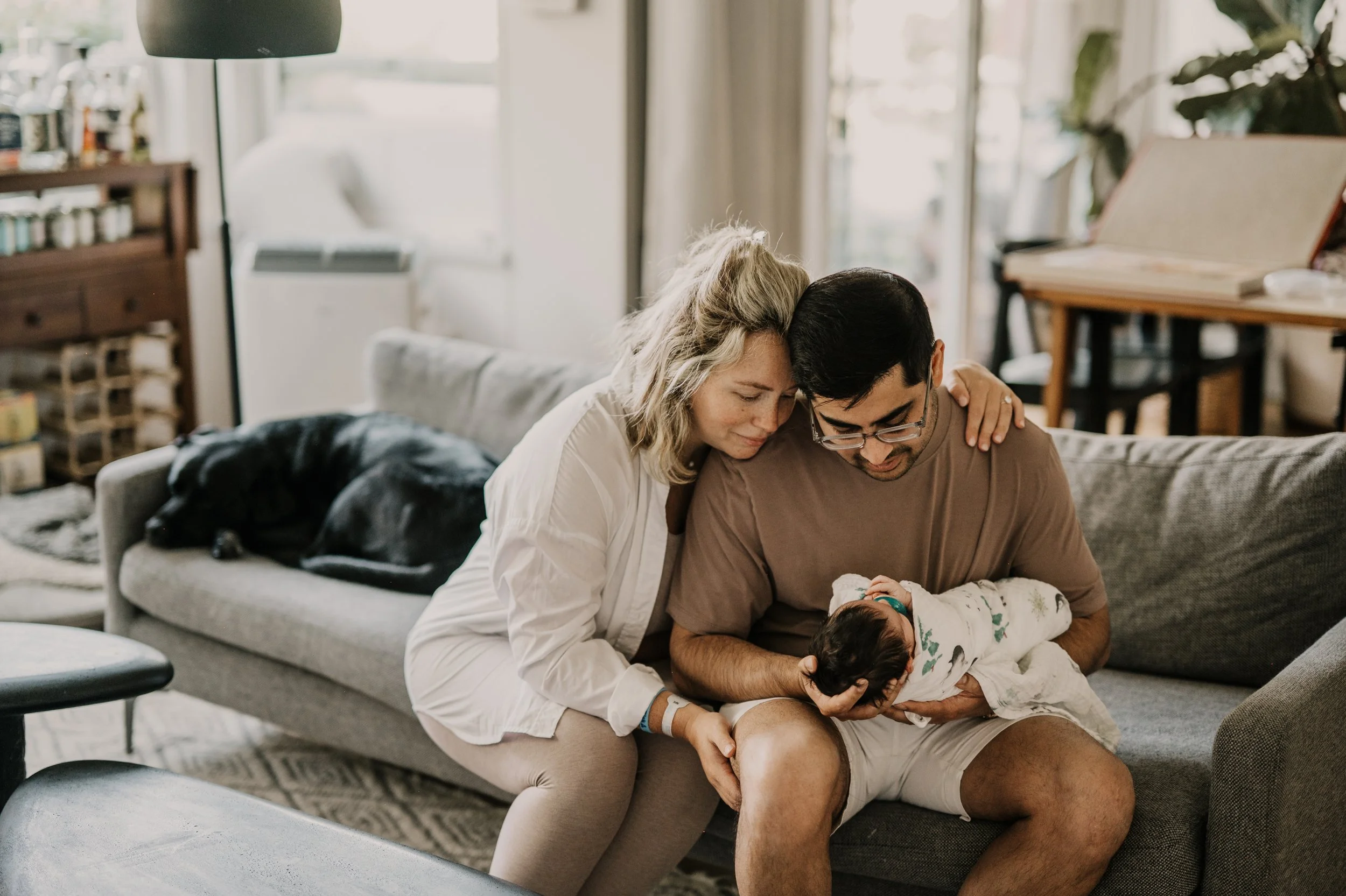 newborn at home family close on couch in home newborn photography