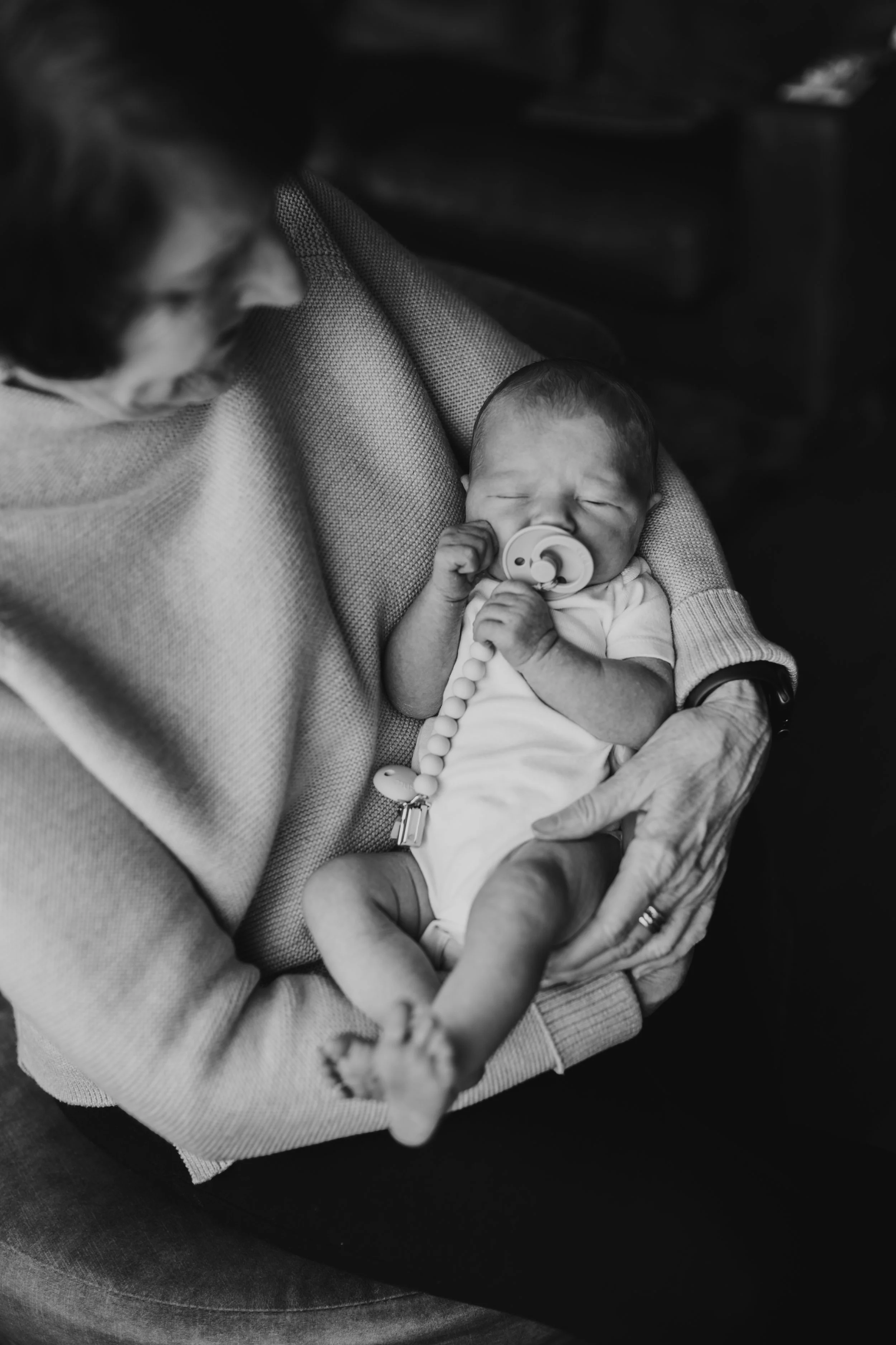 black and white newborn in grandma's arms newborn photography