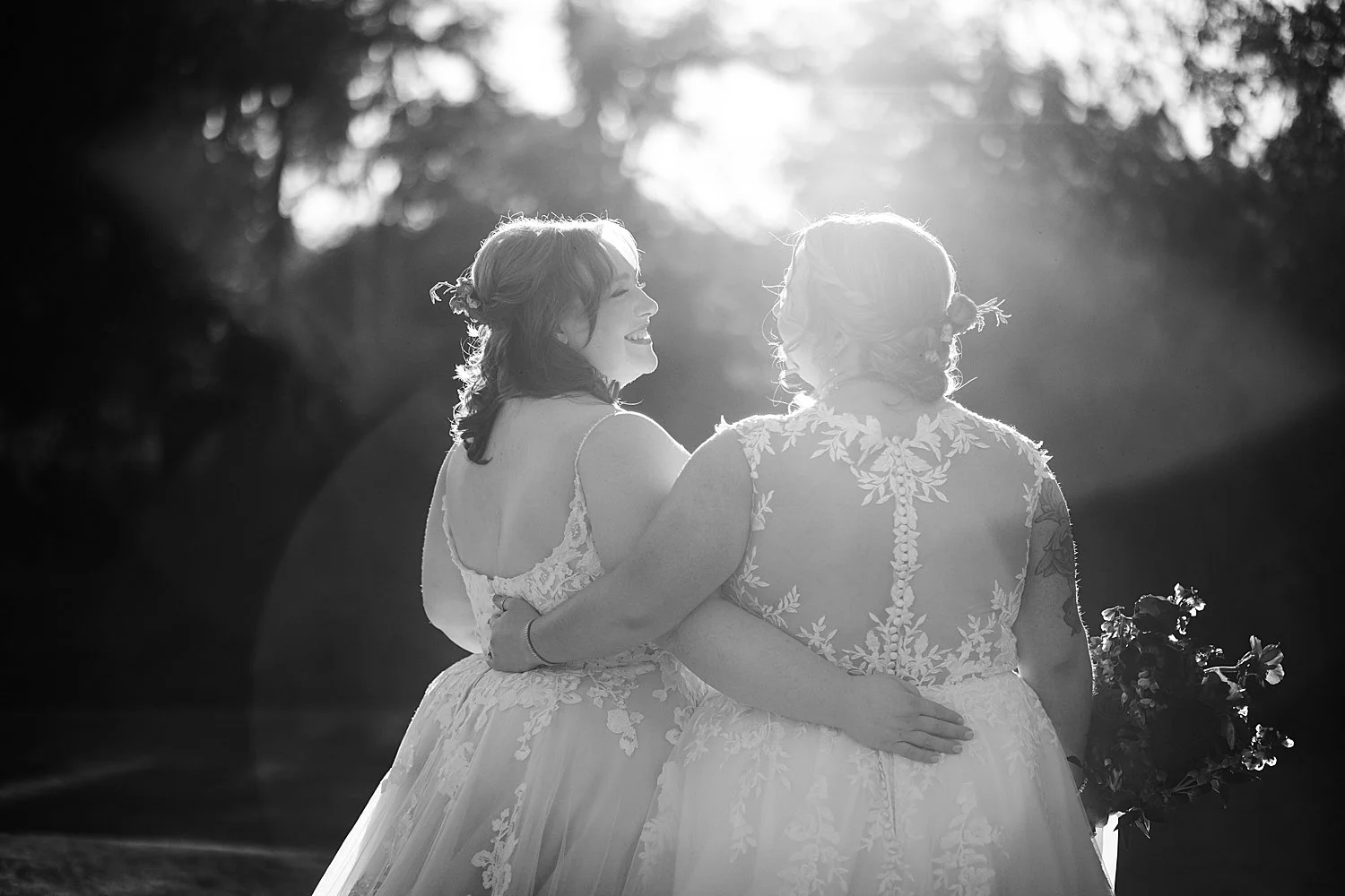 two women have linked arms during golden hour by Dripping Springs wedding photographer