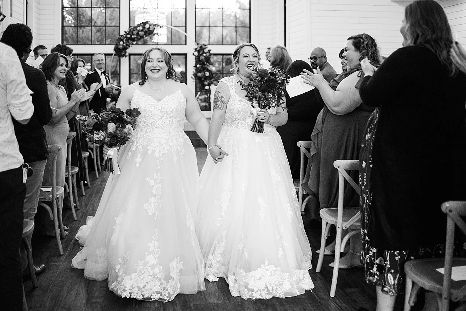 newlyweds walk down the aisle after saying I Do by Shelley Elena Photography