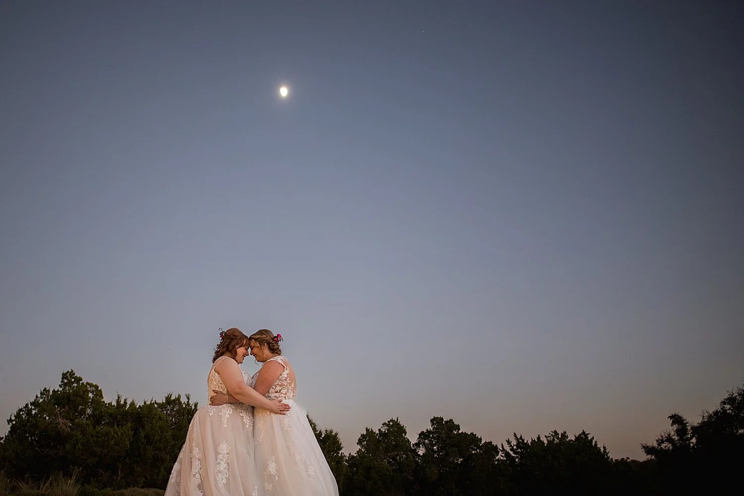 newlyweds embrace outside under the stars by Dripping Springs wedding photographer