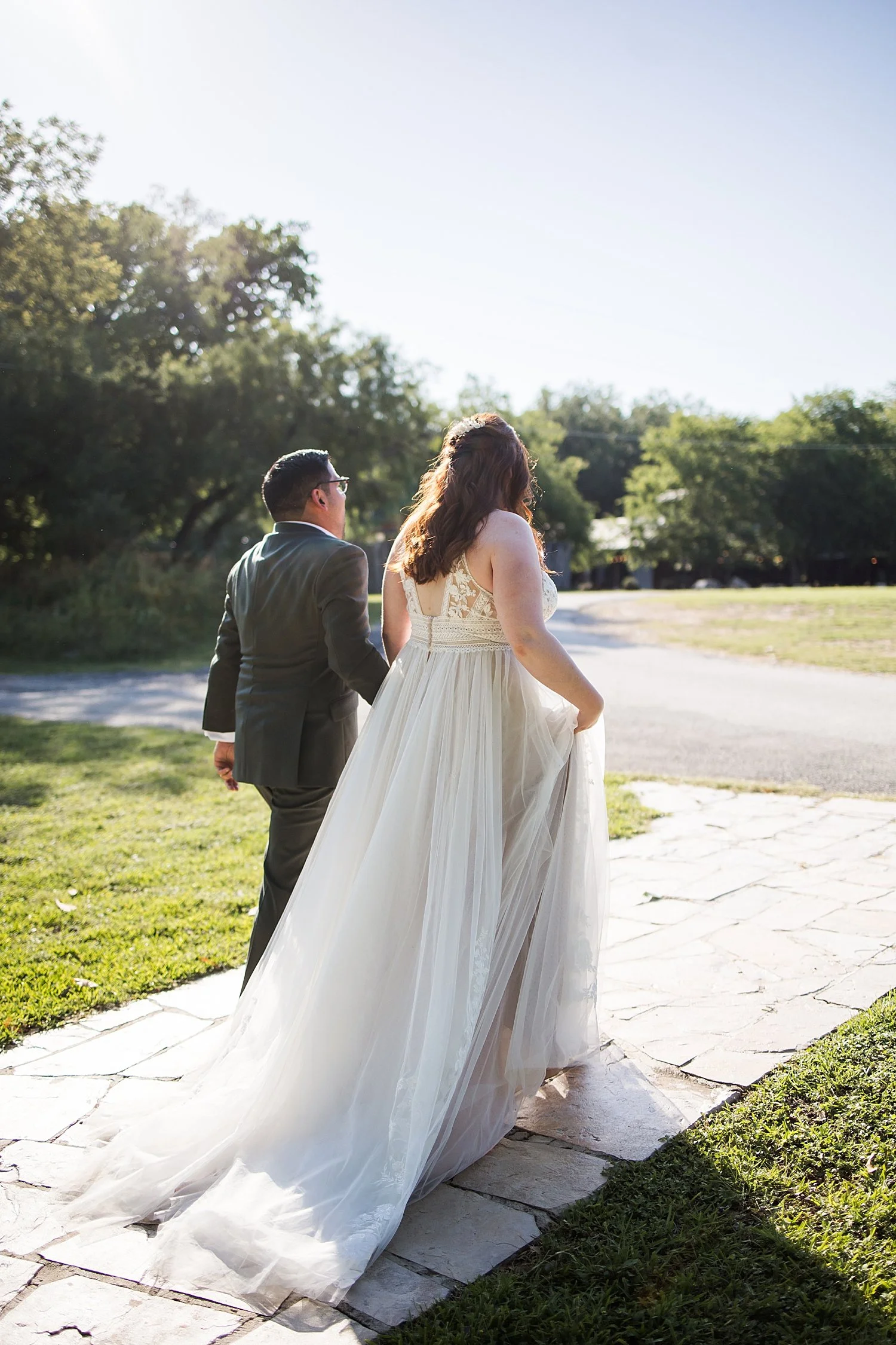 newlyweds exit their ceremony on path by Shelley Elena Photography