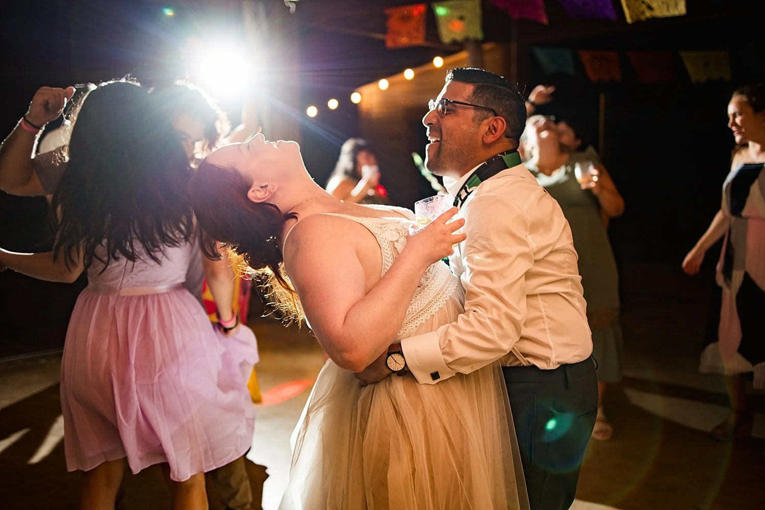 wife throws her head back laughing while dancing by Shelley Elena Photography