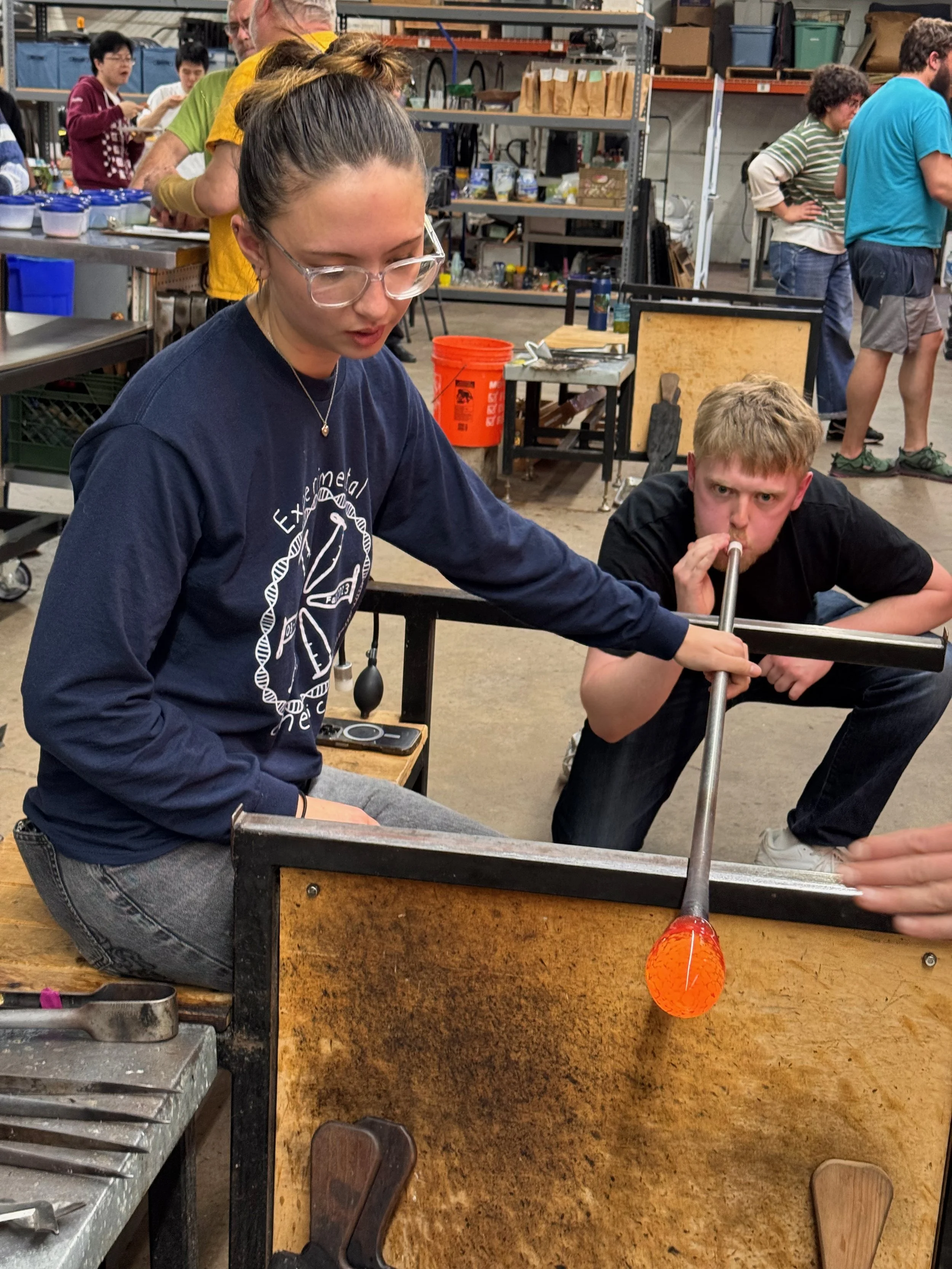 Postgrads work together to make a glass