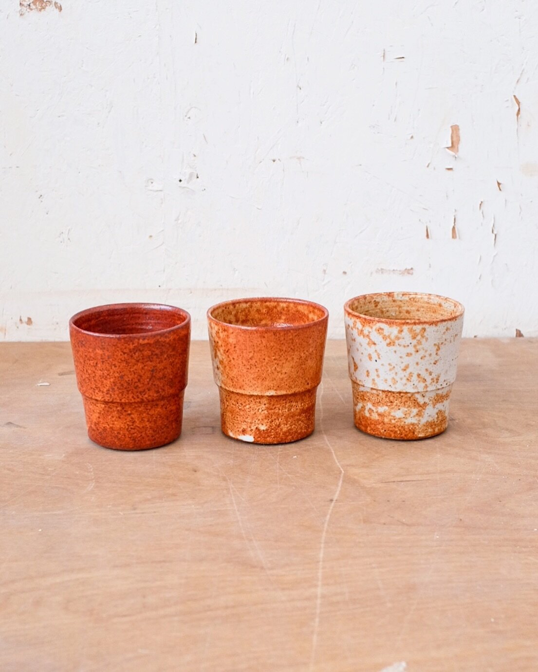 Here are three cups fired in the same glaze in the same kiln. With gas firing, you&rsquo;re not only dealing with fluctuations in temperature but also different levels of reduction. So here, the left cup had a lot of reduction and was probably in a h