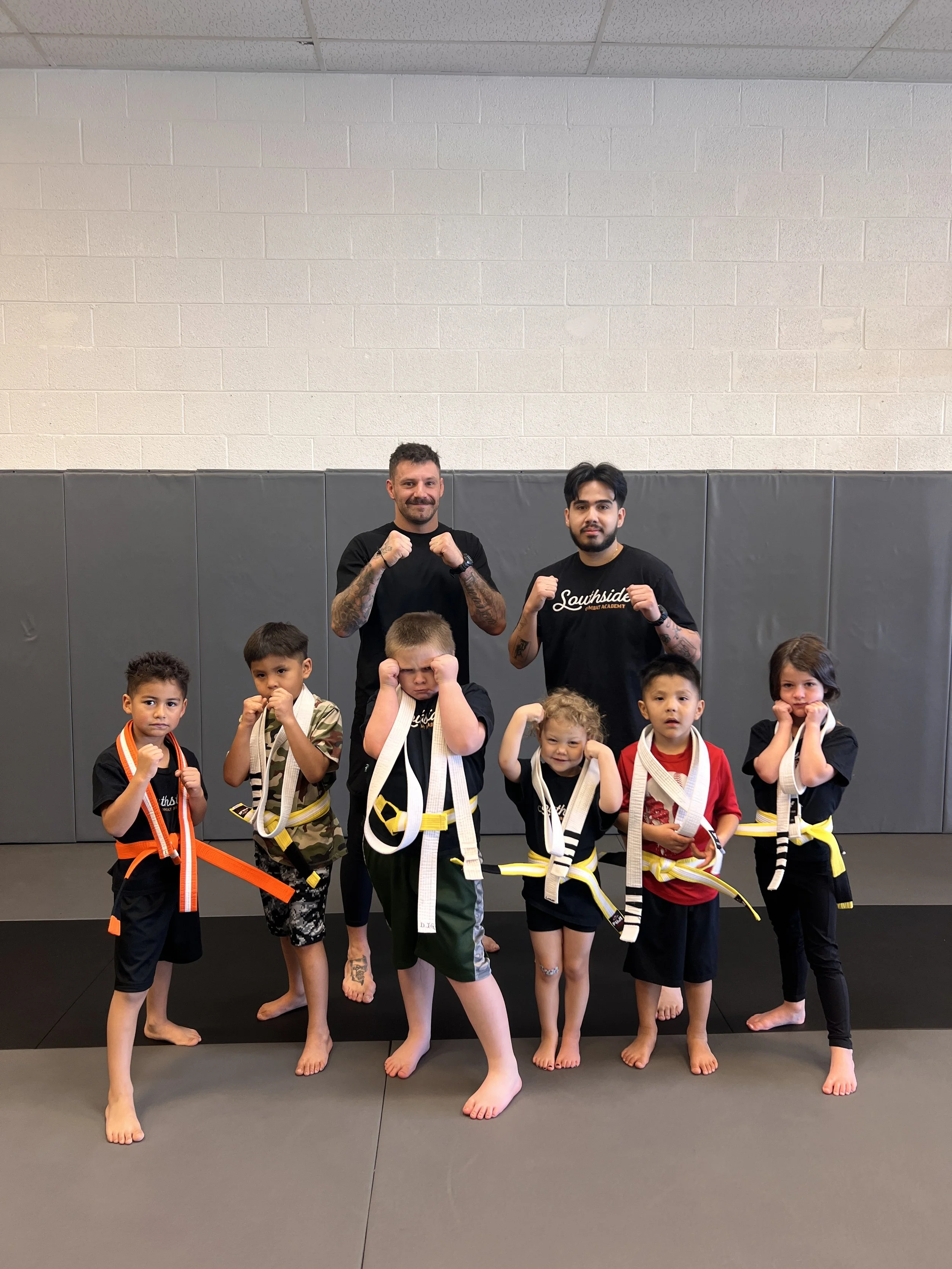 Southside kids coaches with 6 kids after they completed their belt testing