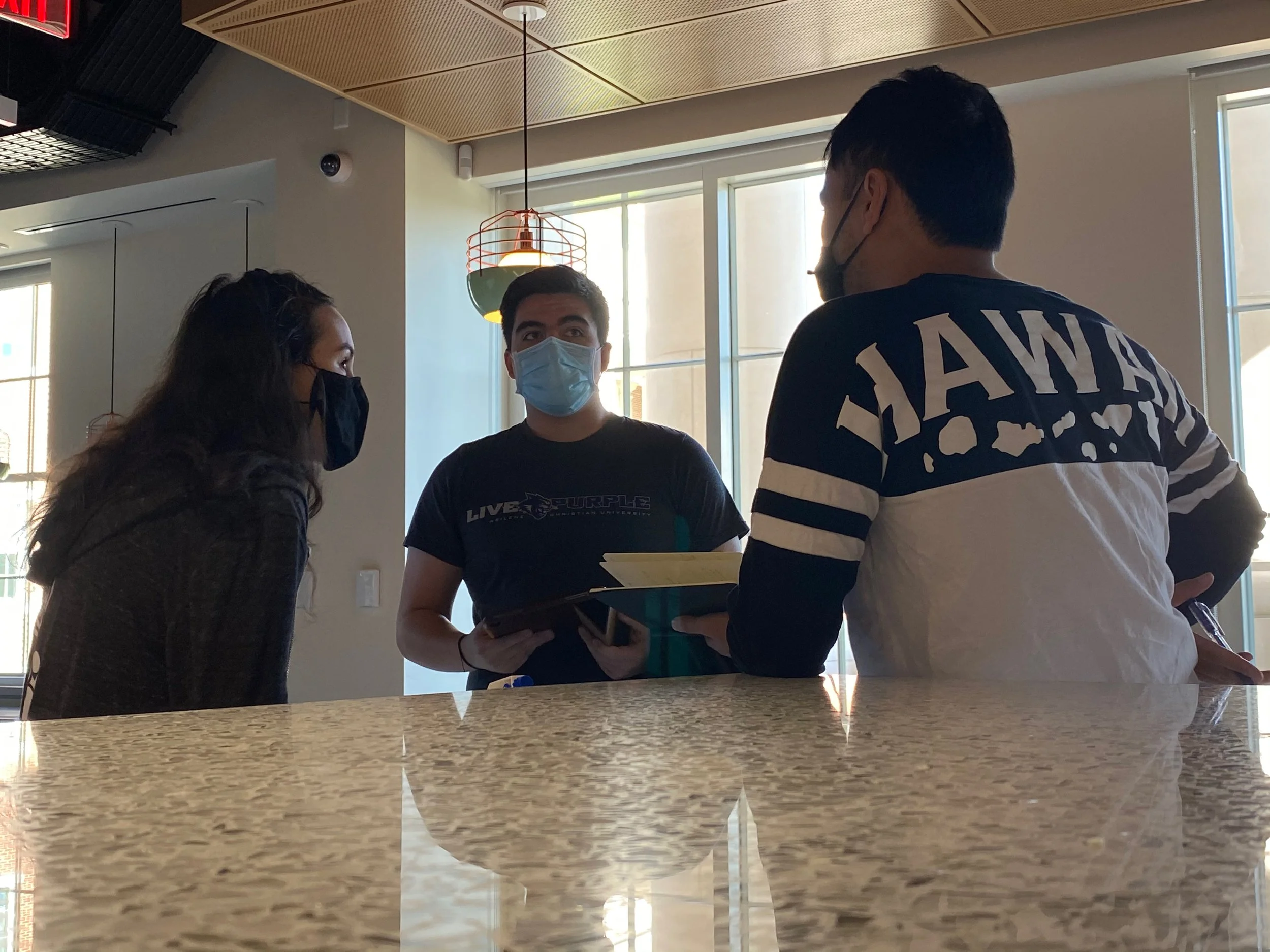 Photograph of Nooka discussing with Daniel and Will.