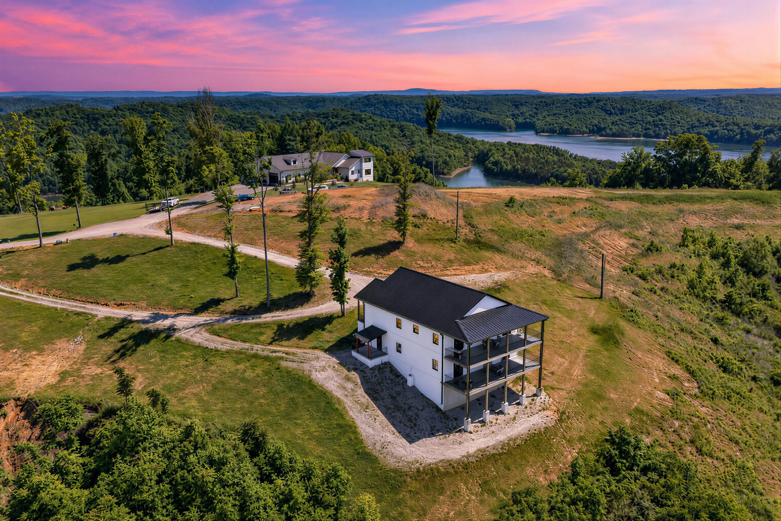 drone image of house on the lake at sunset