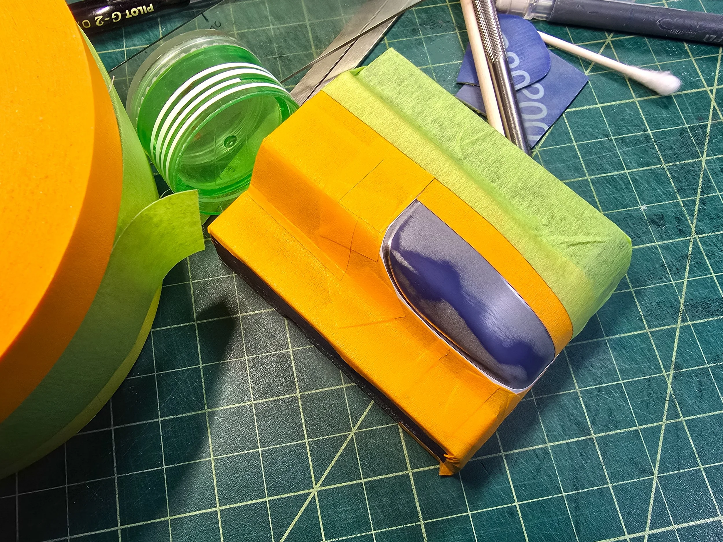 Co-Hog Lola T70 headlight sanded and masked for silver paint