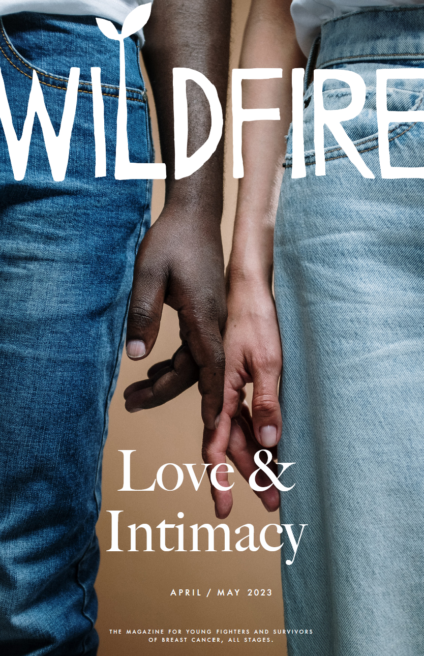 Close-up of two people holding hands, one with dark skin and the other with light skin, with a background of jeans and a beige backdrop. Overlaid text reads 'WILDFIRE Love & Intimacy April / May 2023 The magazine for young fighters and survivors of breast cancer, all stages.'