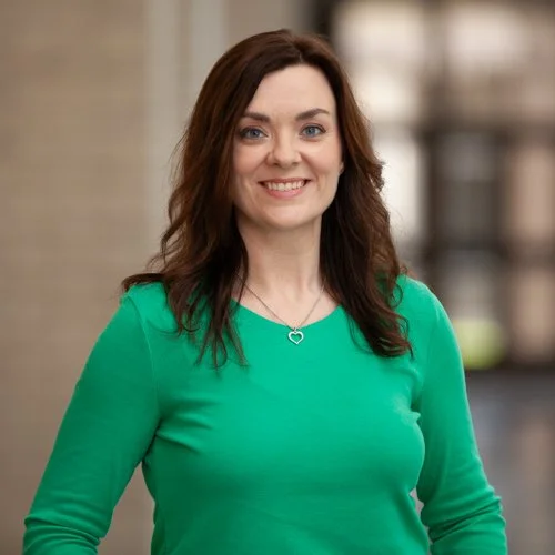Woman in green shirt smiling