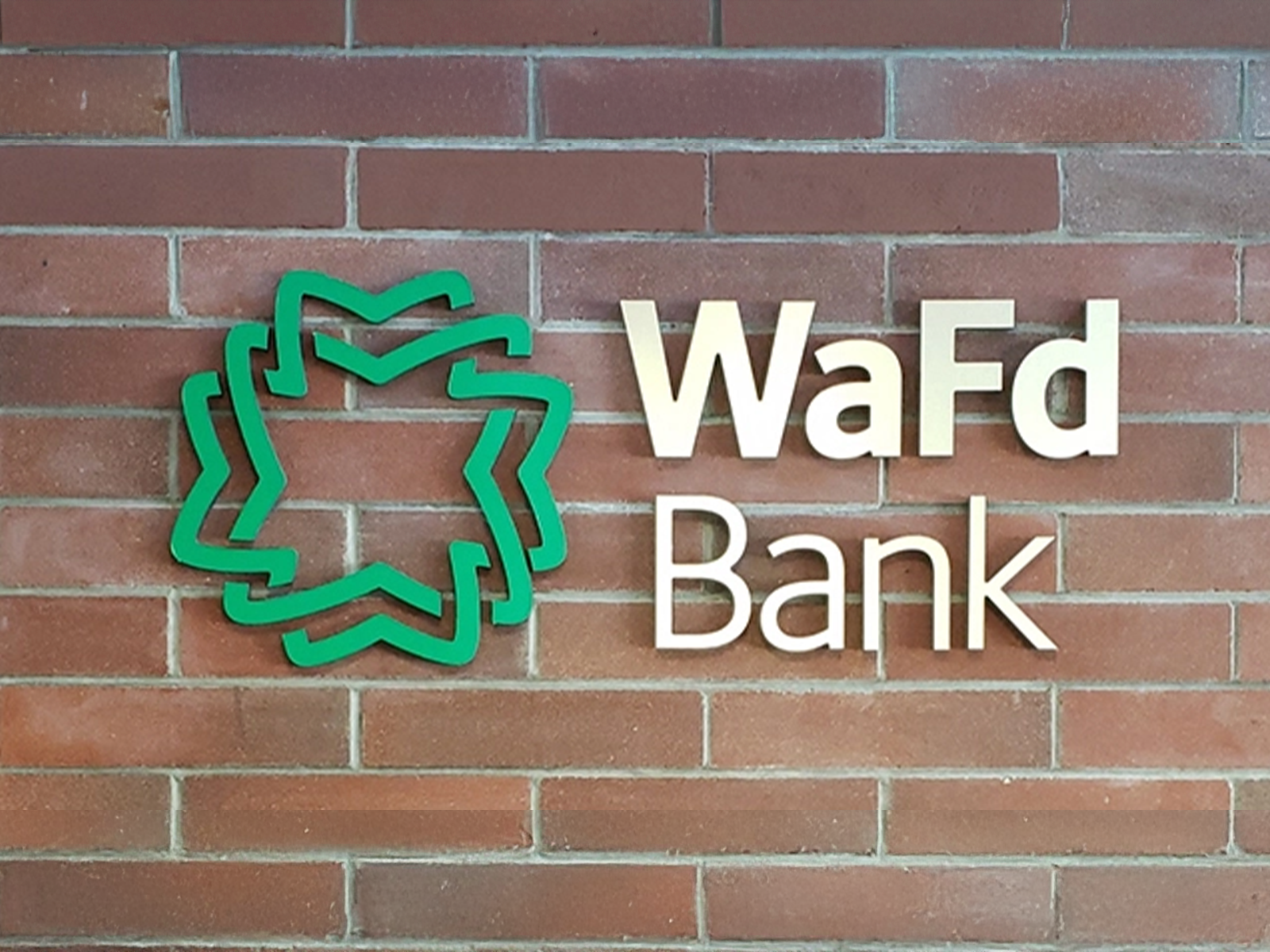 WaFd Bank logo against a brick background