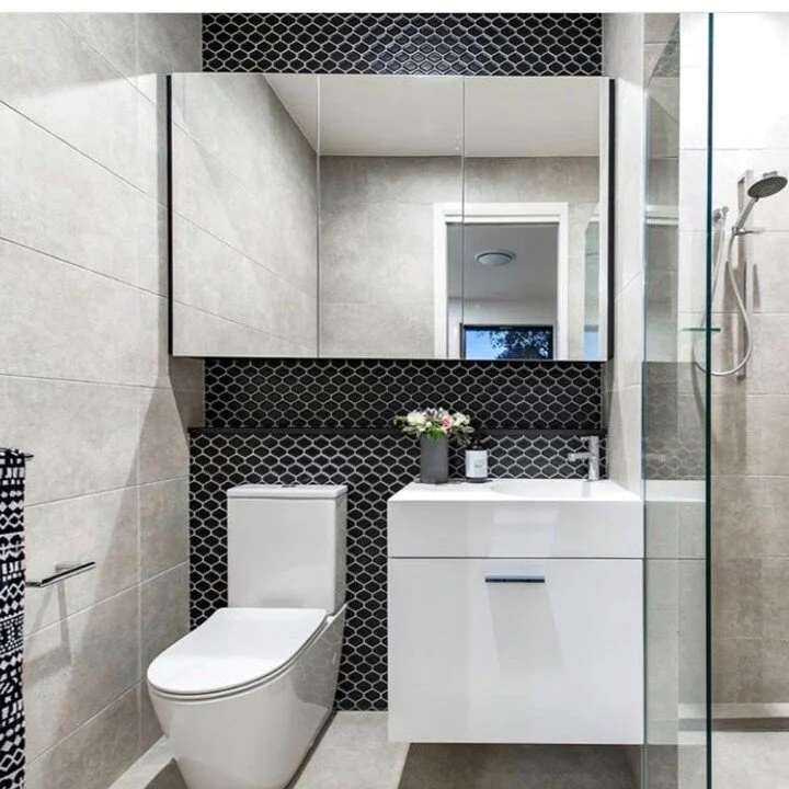 Got a small bathroom? You can make small spaces feel spacious with large format tiles spanning from floor to ceiling. Add in a mirror shaving cabinet and floating cabinetry with storage and your small bathroom no longer looks or feels quite so tiny.
