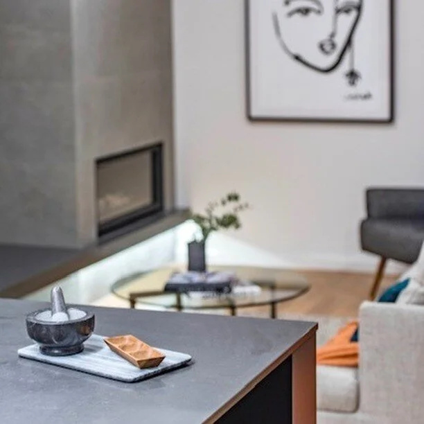 This beautiful fireplace is the focal element of this living room, a perfect space for family and friends to gather on a rainy Canberra day