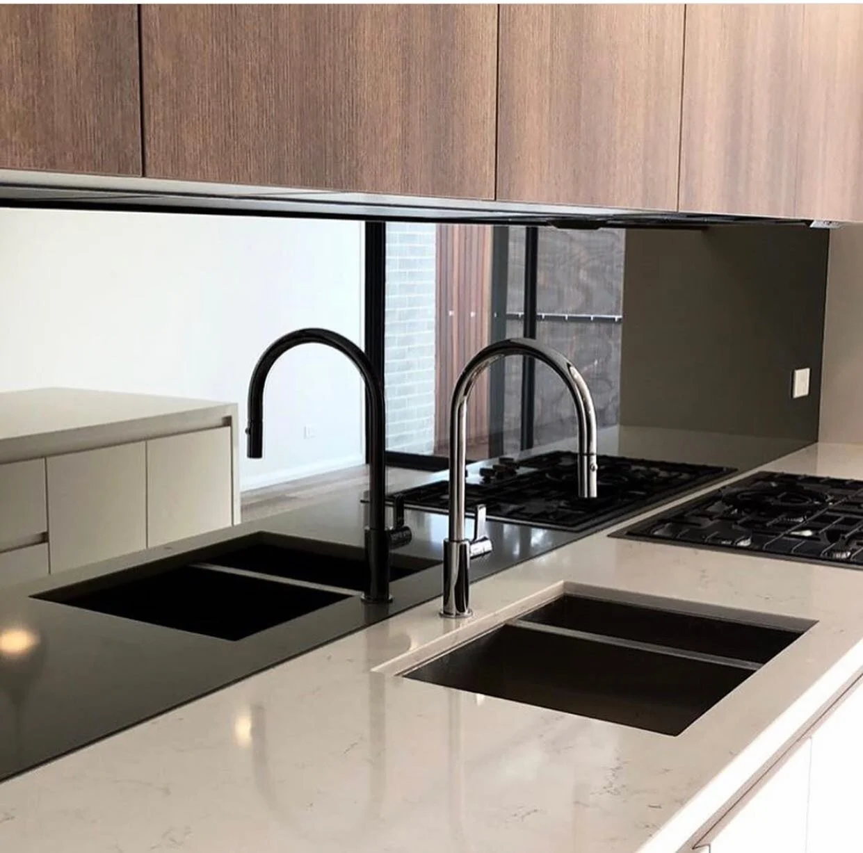 There&rsquo;s a lot to love about the beautiful kitchen at the recently completed Haig Parkside // Carefully placed contrasting cabinetry, elegant brushed nickel tape are tapware and a beautiful smoke mirror splash back  which ties the whole space to