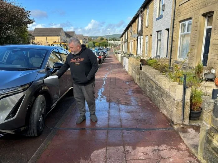 Man charging car with EV cable channel in Lancashire