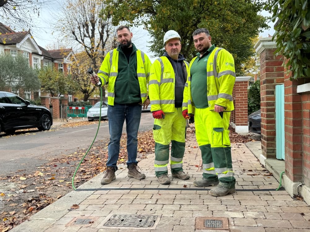 Workmen pictured with newly installed EV cable channel in pavement
