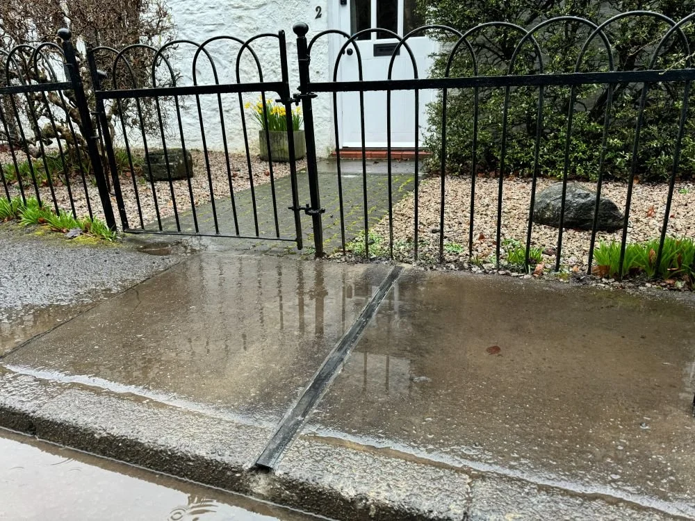 EV Cable channel in pavement outside the front gates of a white house