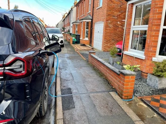 EV parked on West Berkshire street via cross pavement cable channel