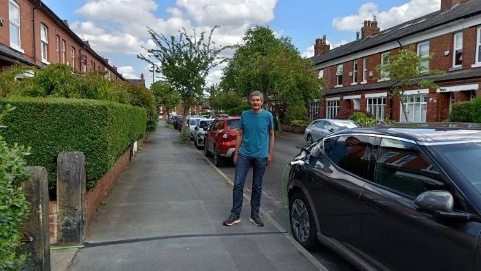 Kerbo Charge customer in Manchester stood next to car being charged