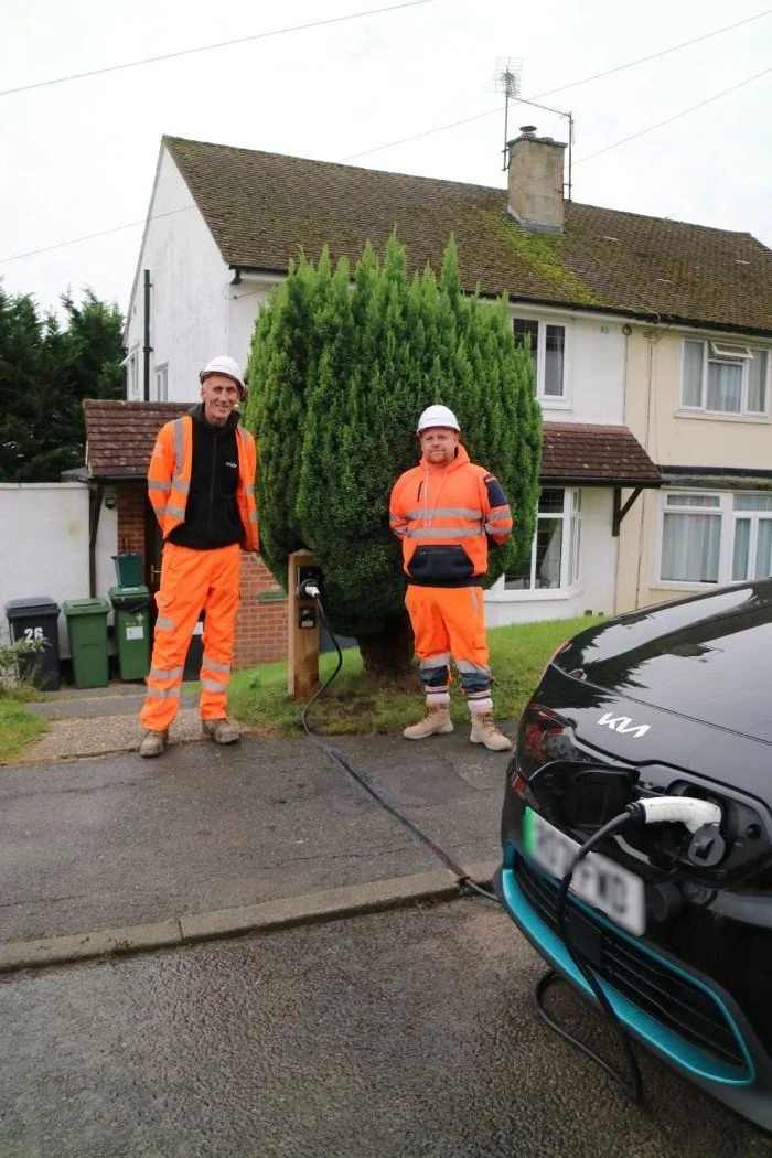 Two installers in high vis standing next to Kerbo Charge EV cable channel