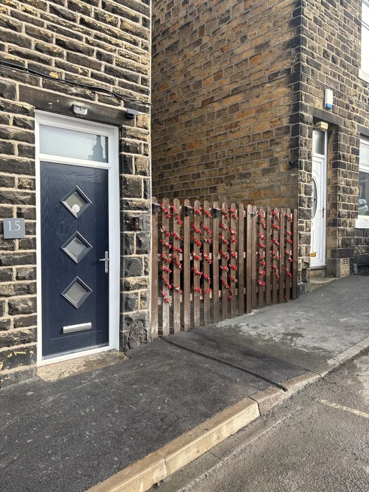 Front doow of terraced house with EV charge gully in pavement outside