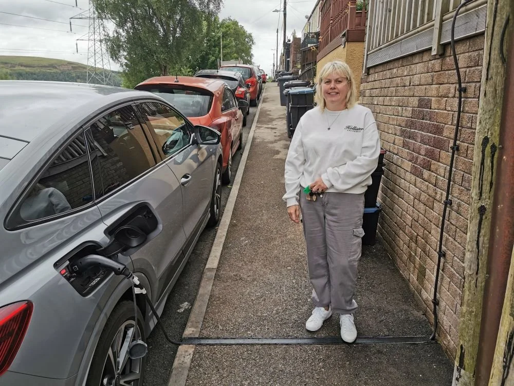 lady stood on newly installed EV cable channel in the pavement