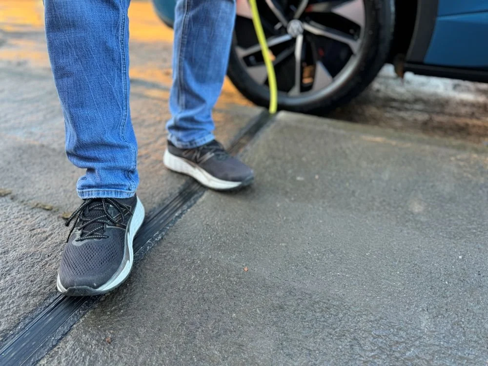 Man standing on top of Kerbo Charge EV Channel in pavement