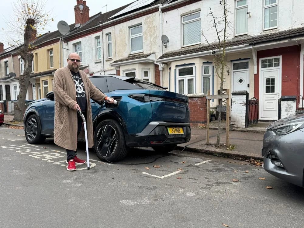 Coventry resident using Kerbo Charge gully to Charge EV on the street outside home