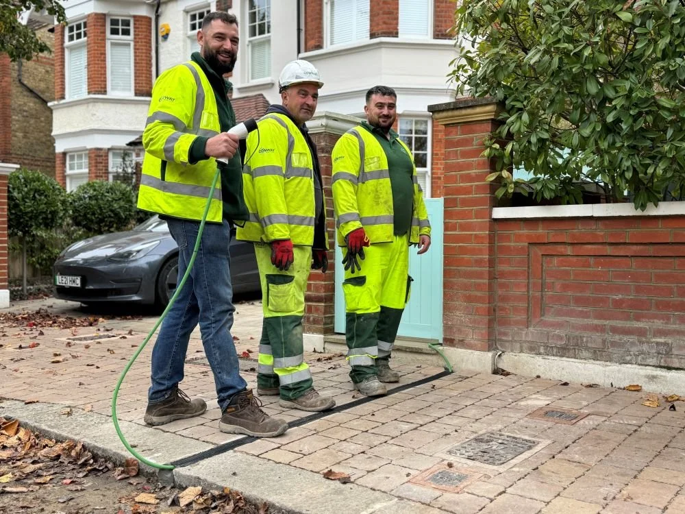 3 Kerbo Charge Installers on pavement with EV cable gully