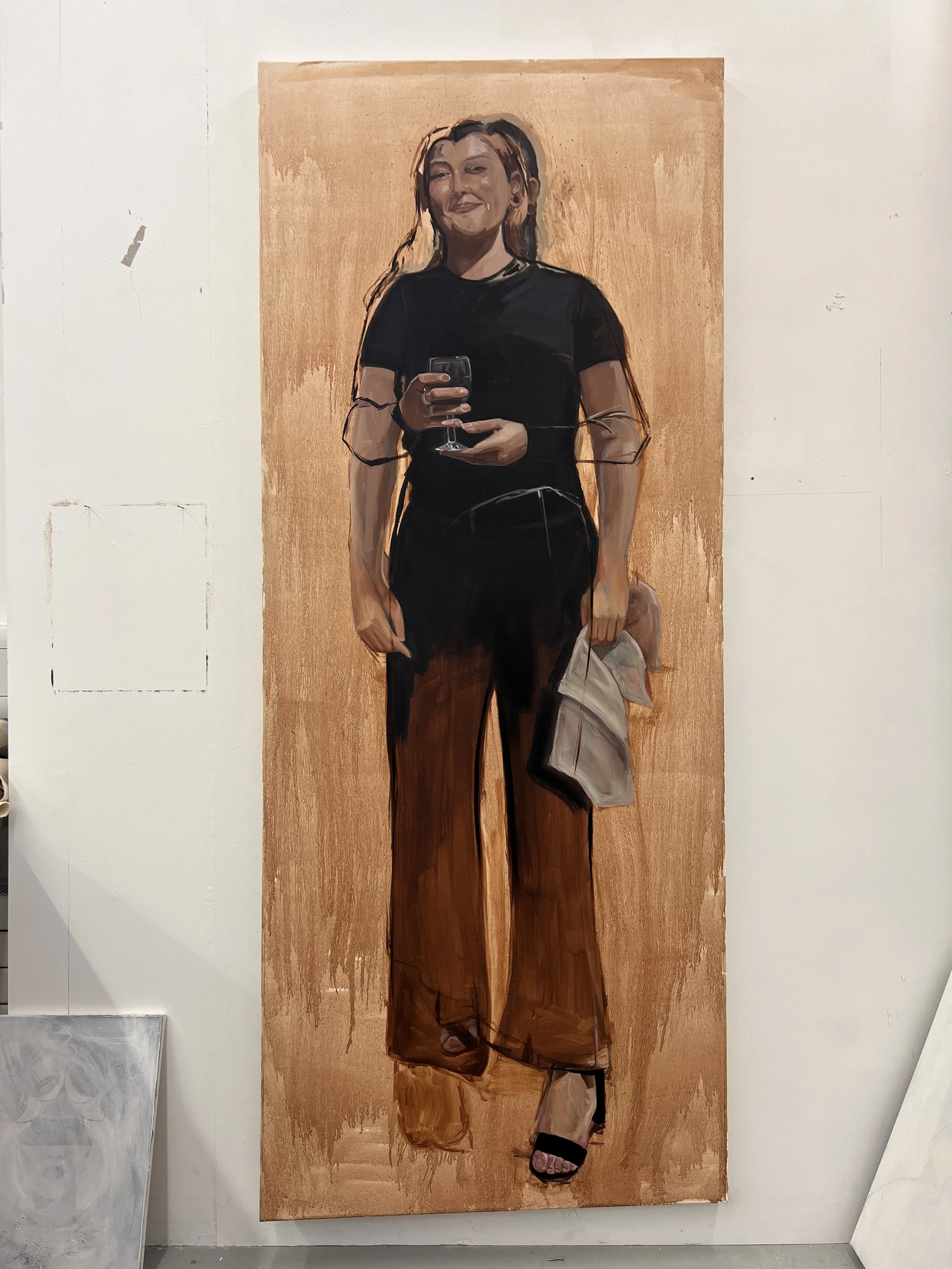 A painting of a woman taking a selfie with her phone. She is dressed in black with brown pants and wearing black sandals, standing against a light-colored background.