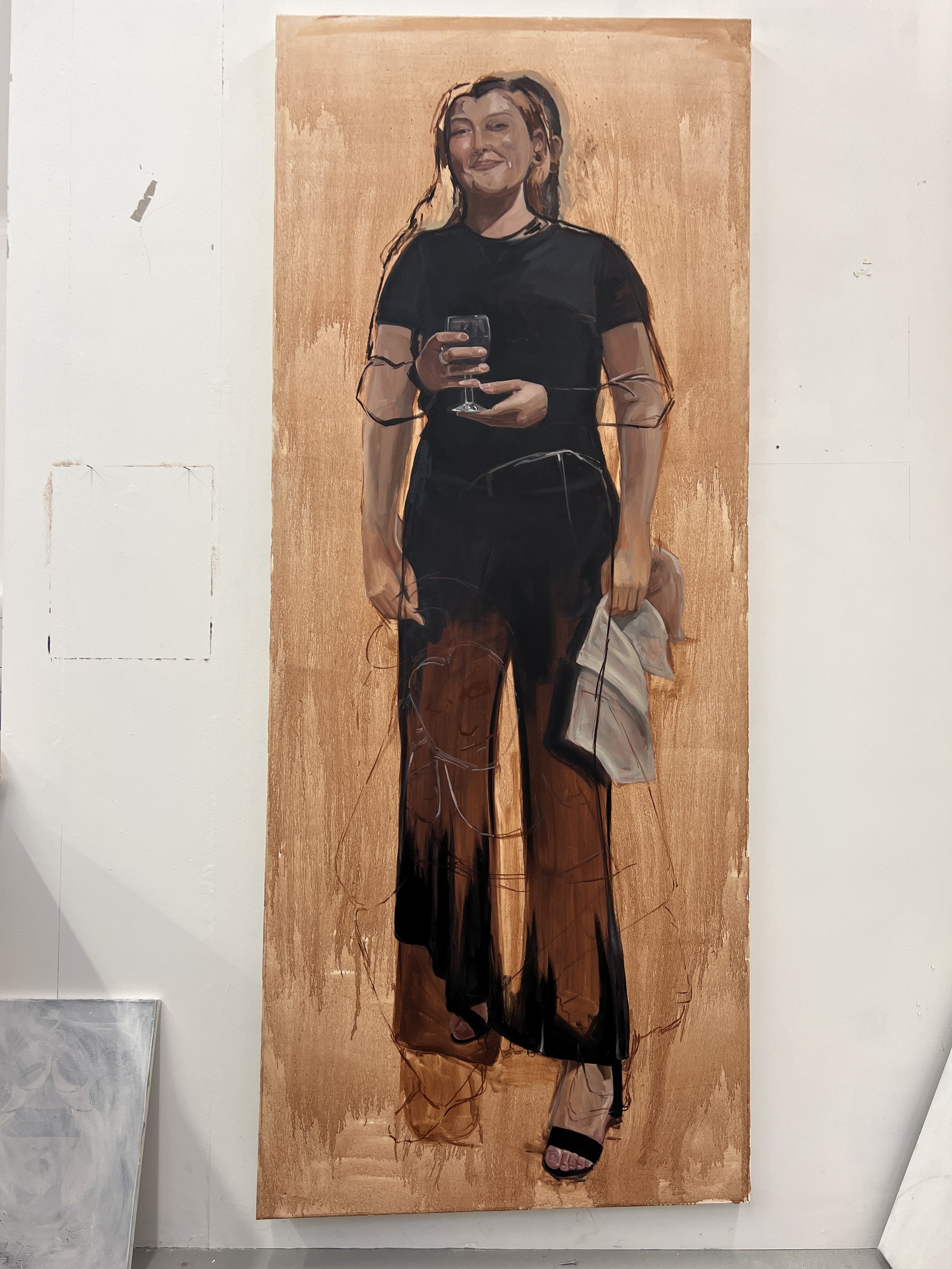 A painting of a woman standing, holding a wine glass, dressed in black pants and a black top, smiling with a casual pose.