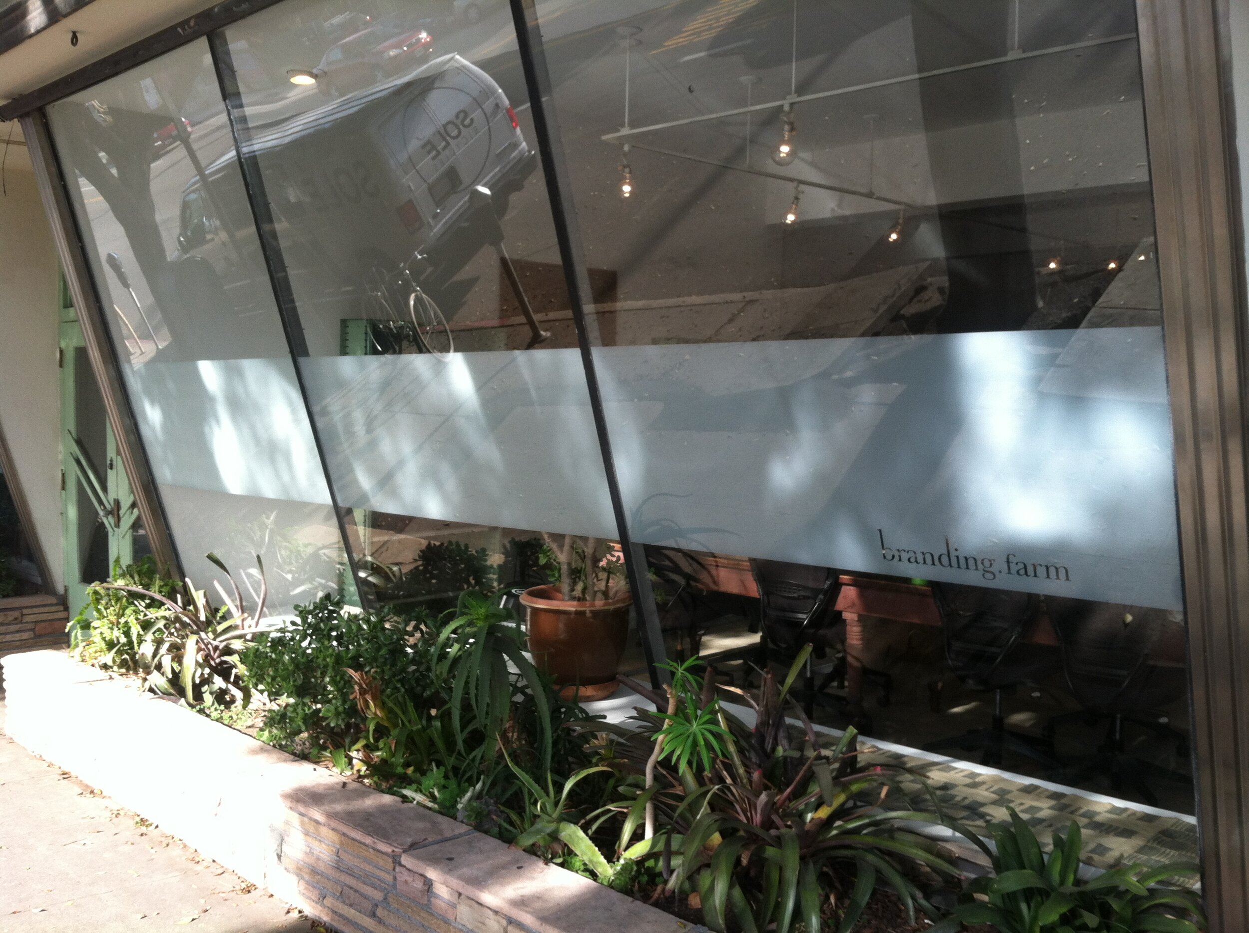Custom logo for storefront window cut out of negative space. We provide window film installation, custom logos from cut vinyl, large format digital printing and more.