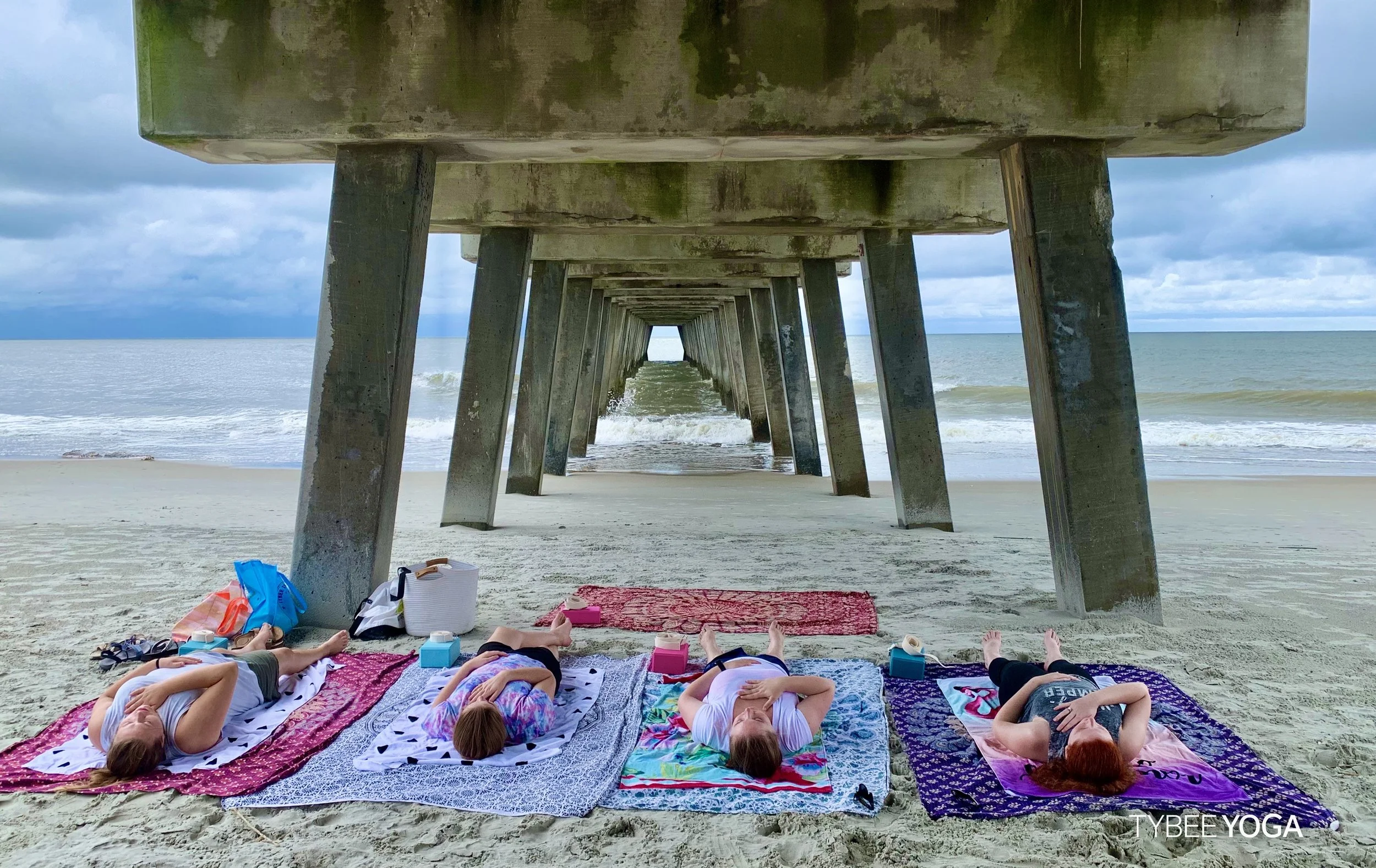 Beach Yoga under the Pier at Tybee Island, Ga