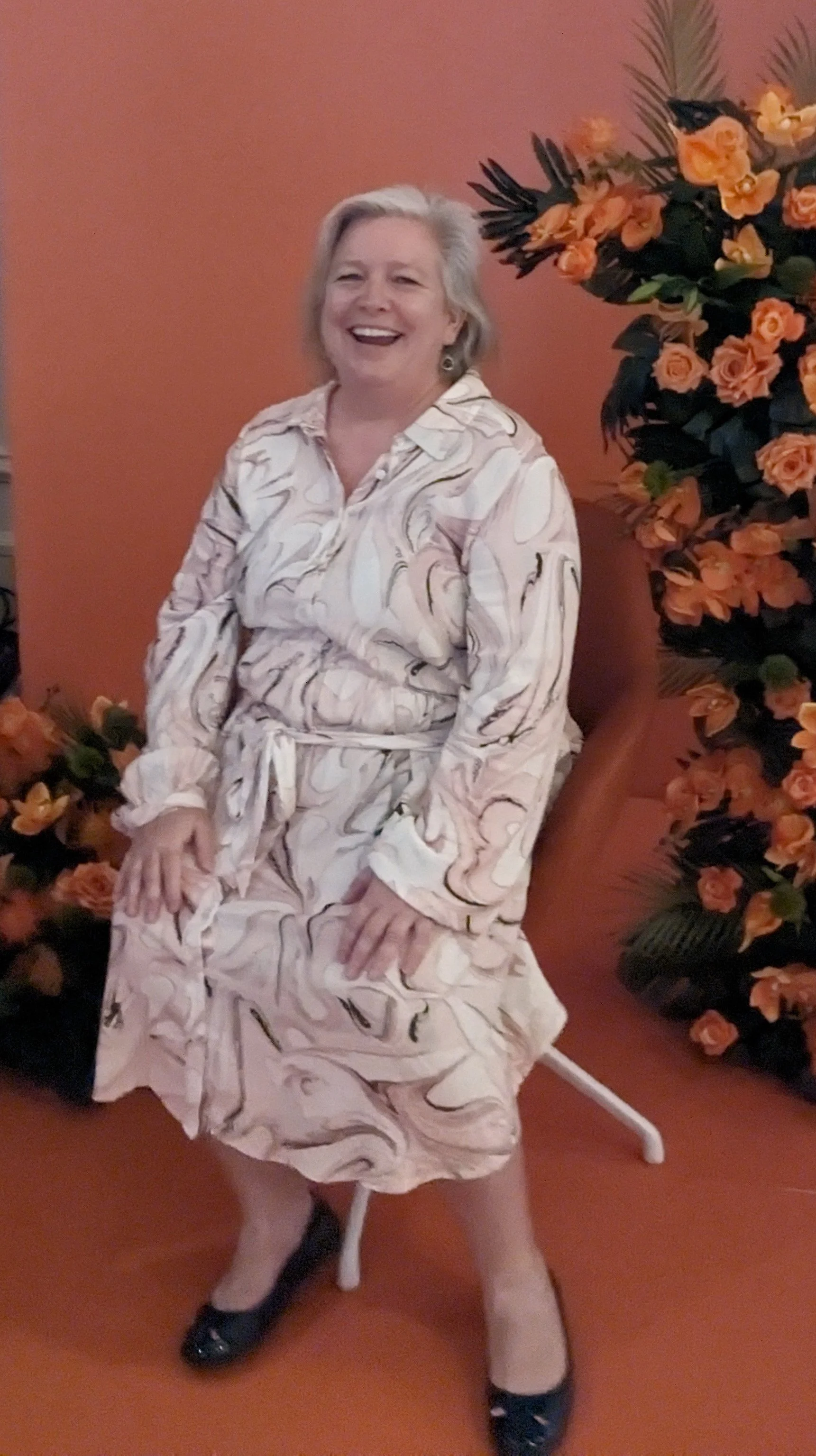 JJ Jank smiling and wearing a dress