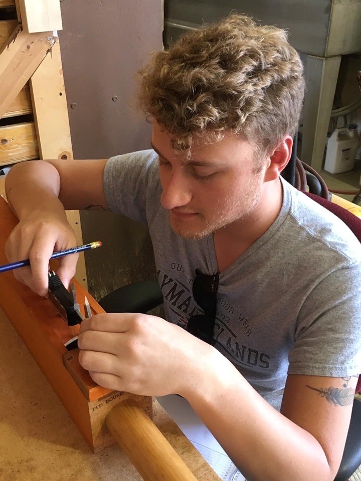 Parker MacIver Hinnenkamp measures the scaling of wooden pipes from a Kilgen organ to chart data needed to archive and reproduce this rank at a later date.