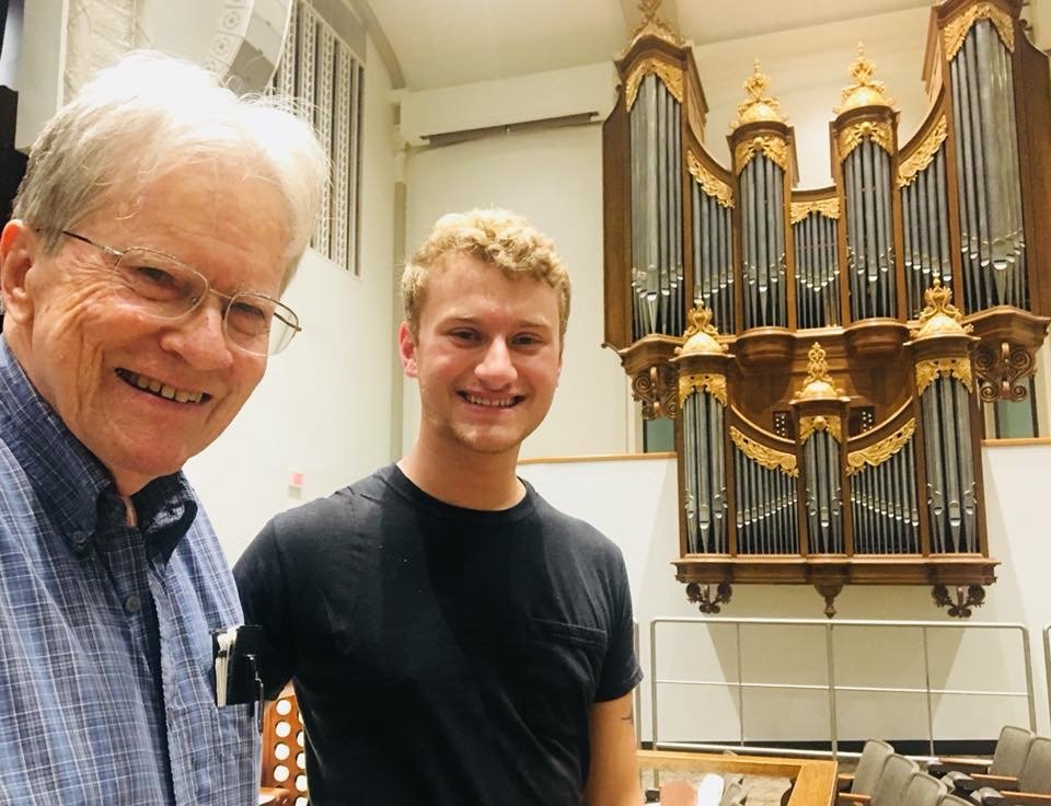 Parker MacIver Hinnenkamp tunes the organs with Roy Redman in front of the Bedient French Classical organ in UNT's Main Auditorium.
